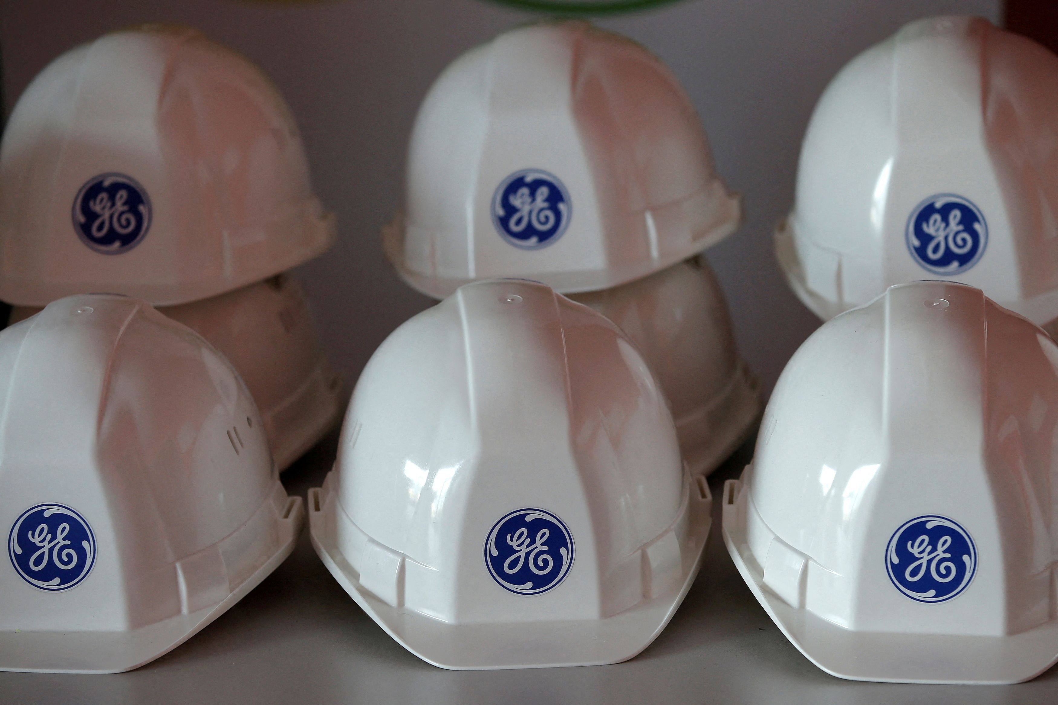 The General Electric logo is pictured on working helmets during a visit at the General Electric offshore wind turbine plant in Montoir-de-Bretagne