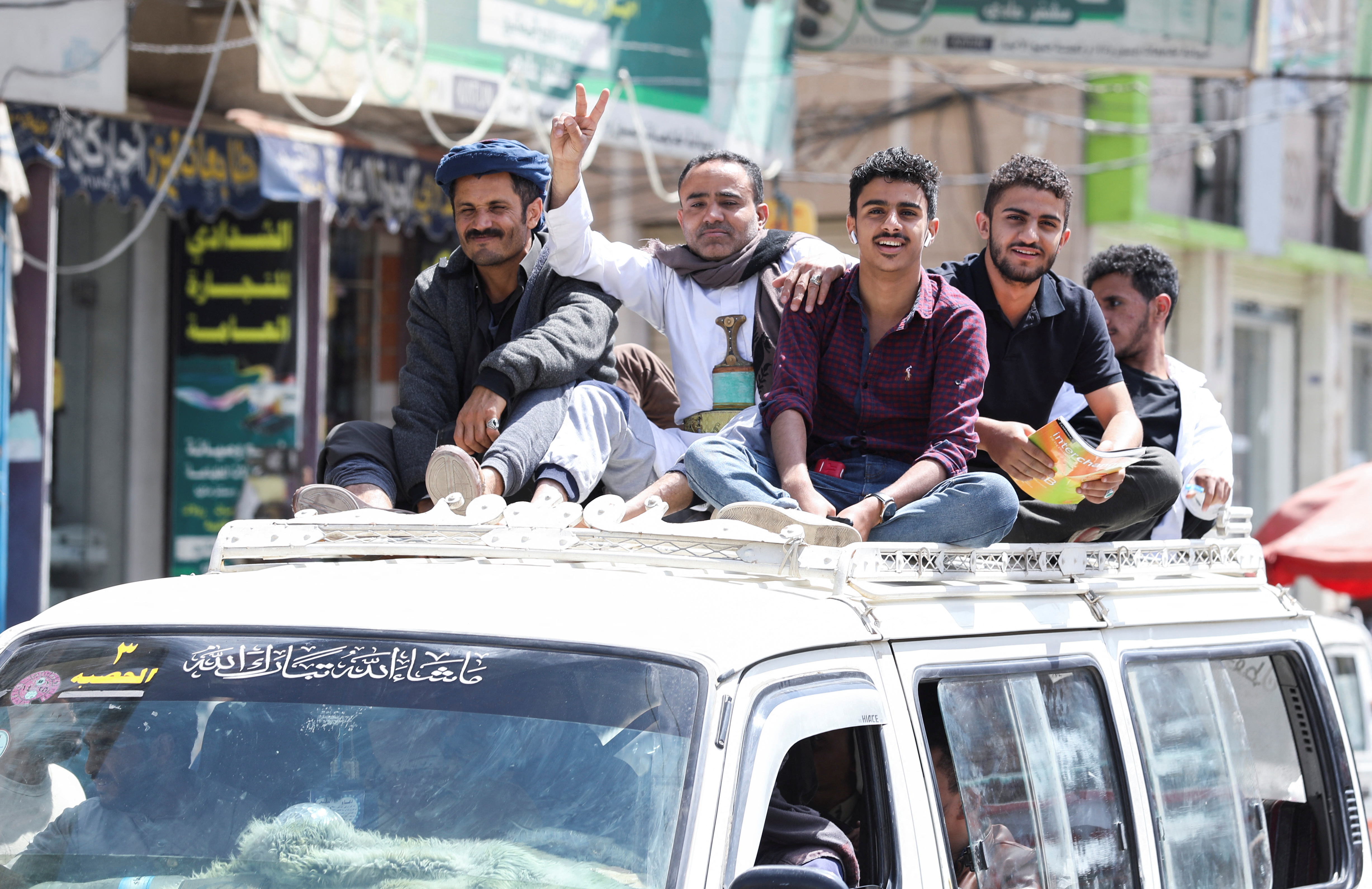 People ride atop a crowded taxi van amid acute fuel shortages in Sanaa