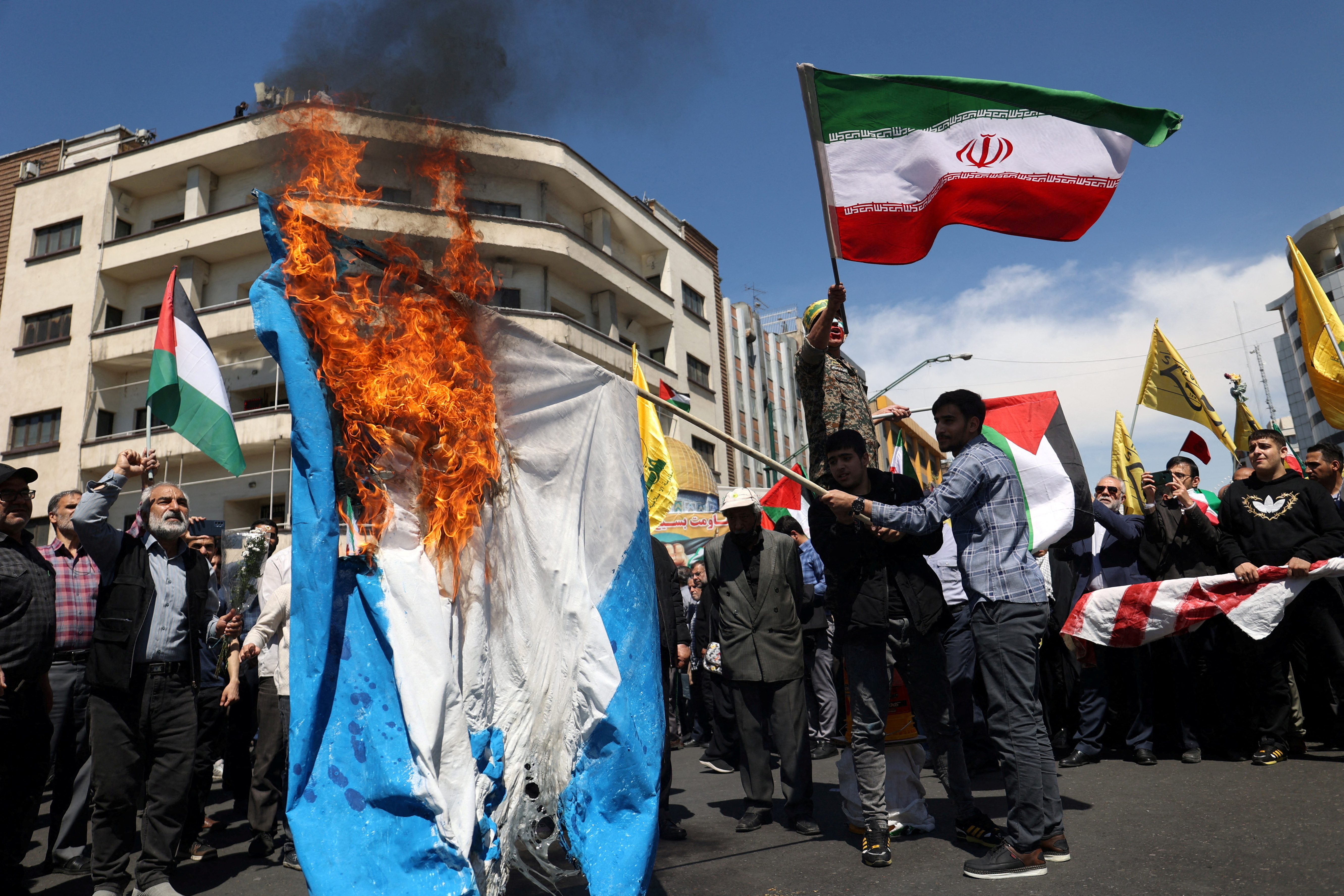 Iranians attend a rally marking Quds Day and the funeral of members of the Islamic Revolutionary Guard Corps, in Tehran