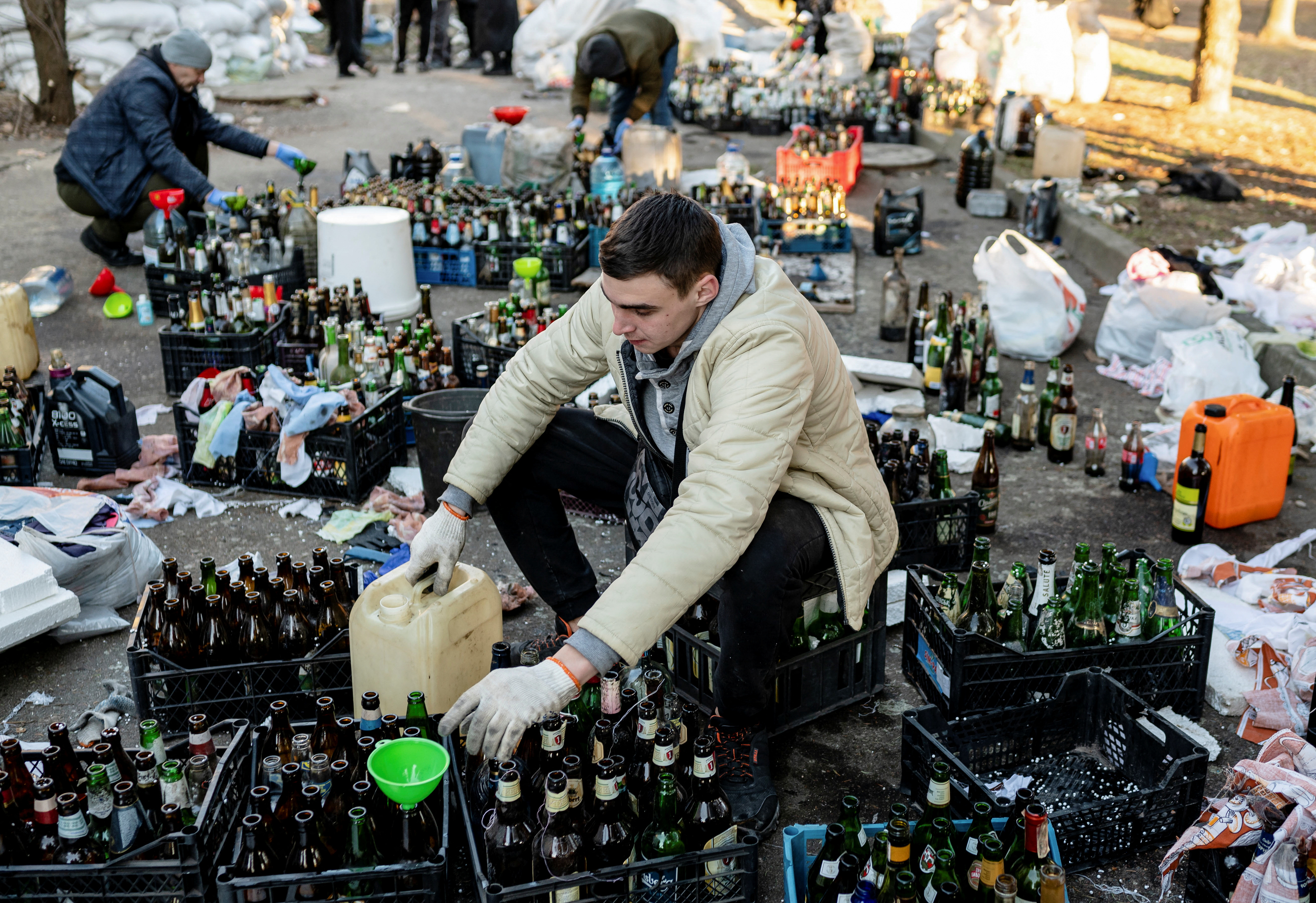 Local residents prepare Molotov cocktails to defend their city, in Zhytomyr