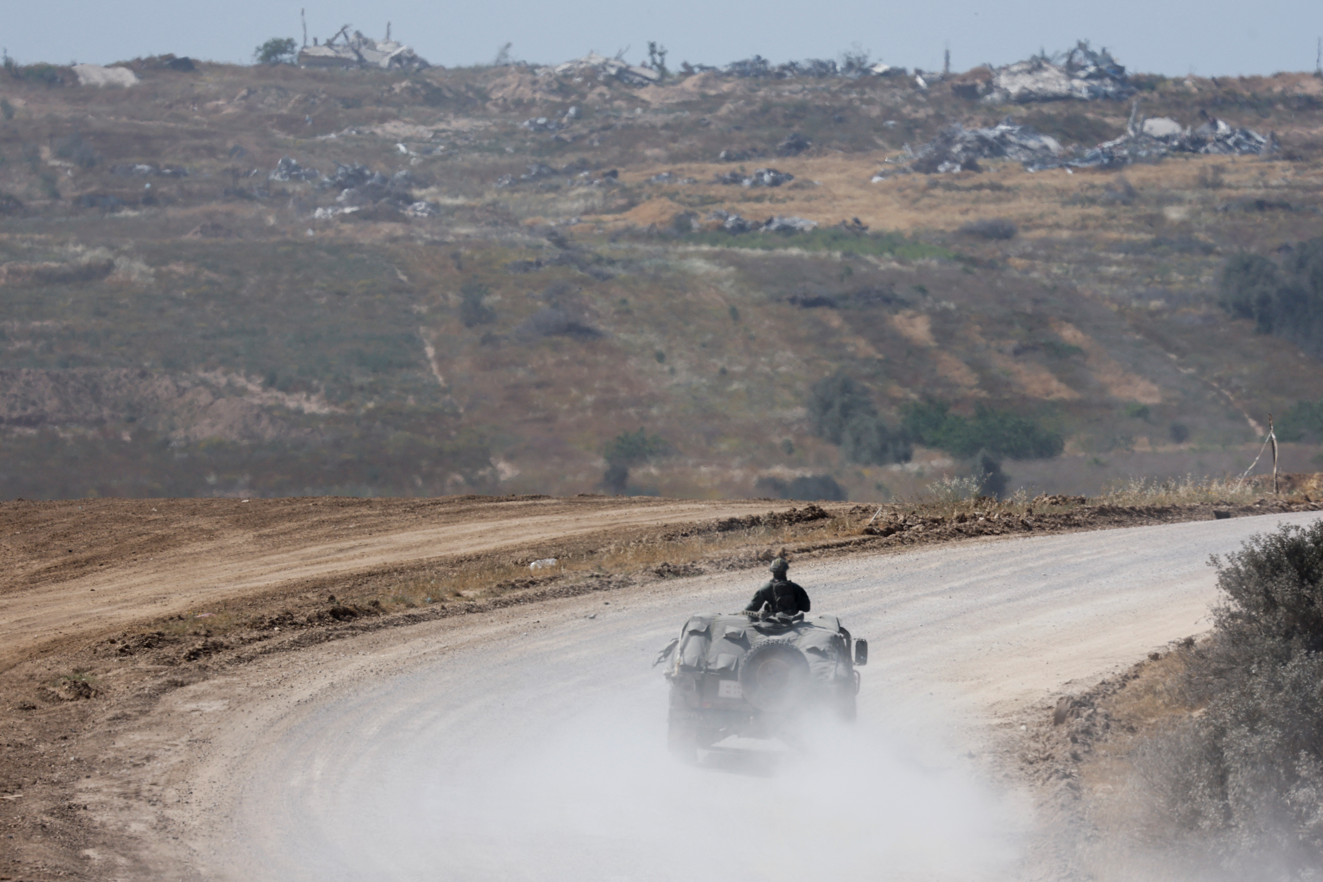 Israeli military vehicles manoeuvre, near the Israel-Gaza border