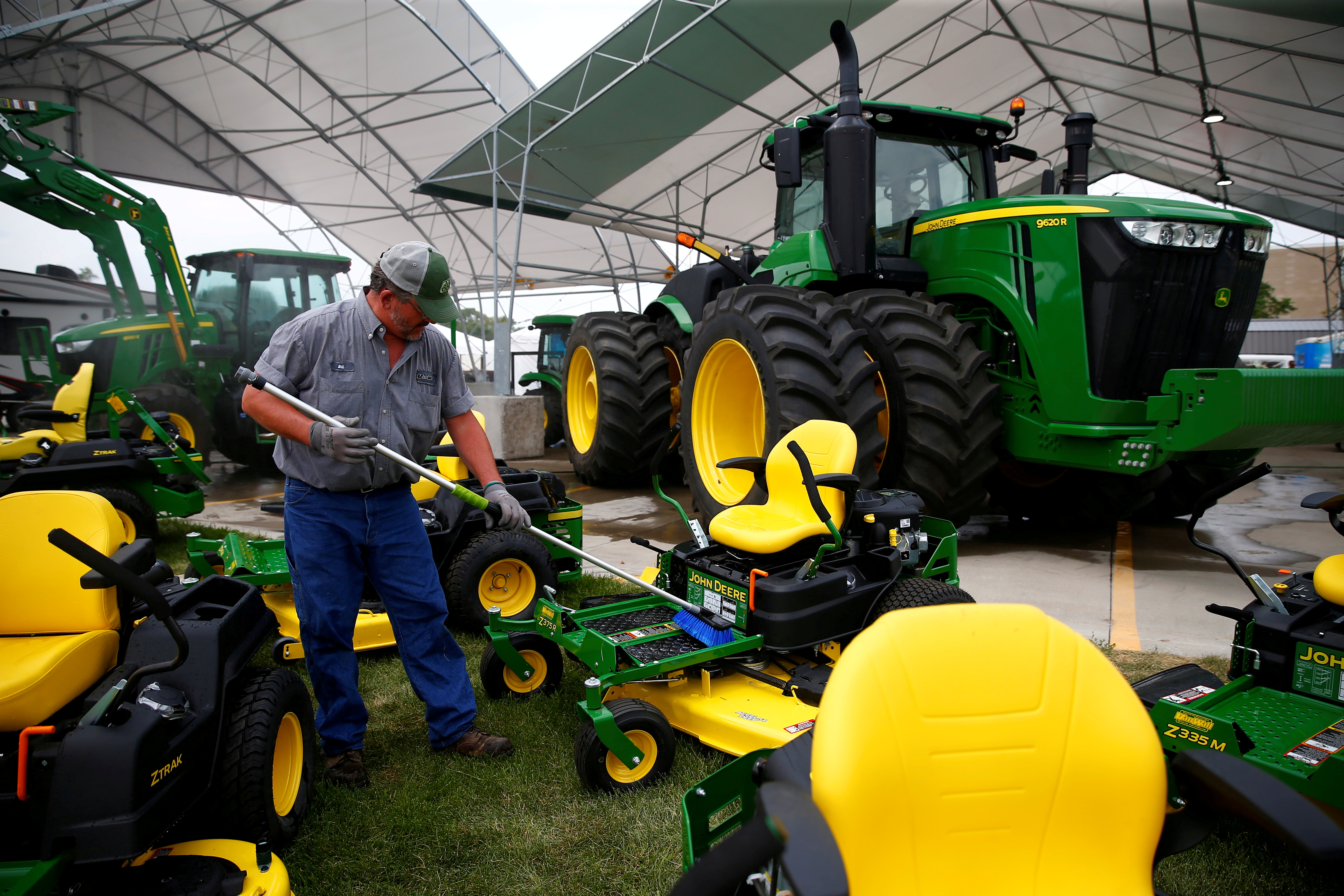 A man cleans farm machinery as people prepare for the Iowa State Fair in Des Moines, Iowa, U.S. August 5, 2019. REUTERS/Eric Thayer/File Photo