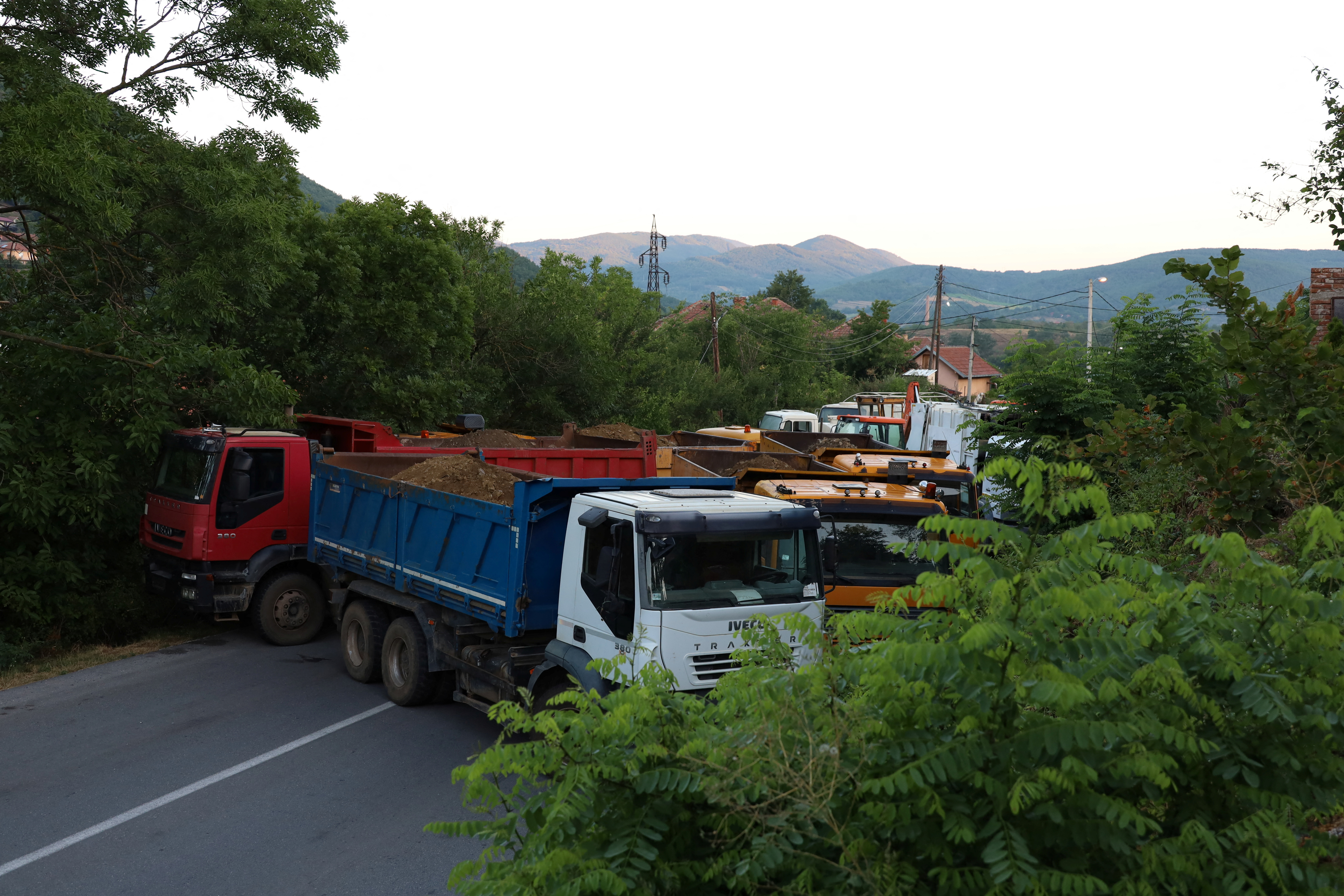 A general view shows trucks blocking thae road in Rudare