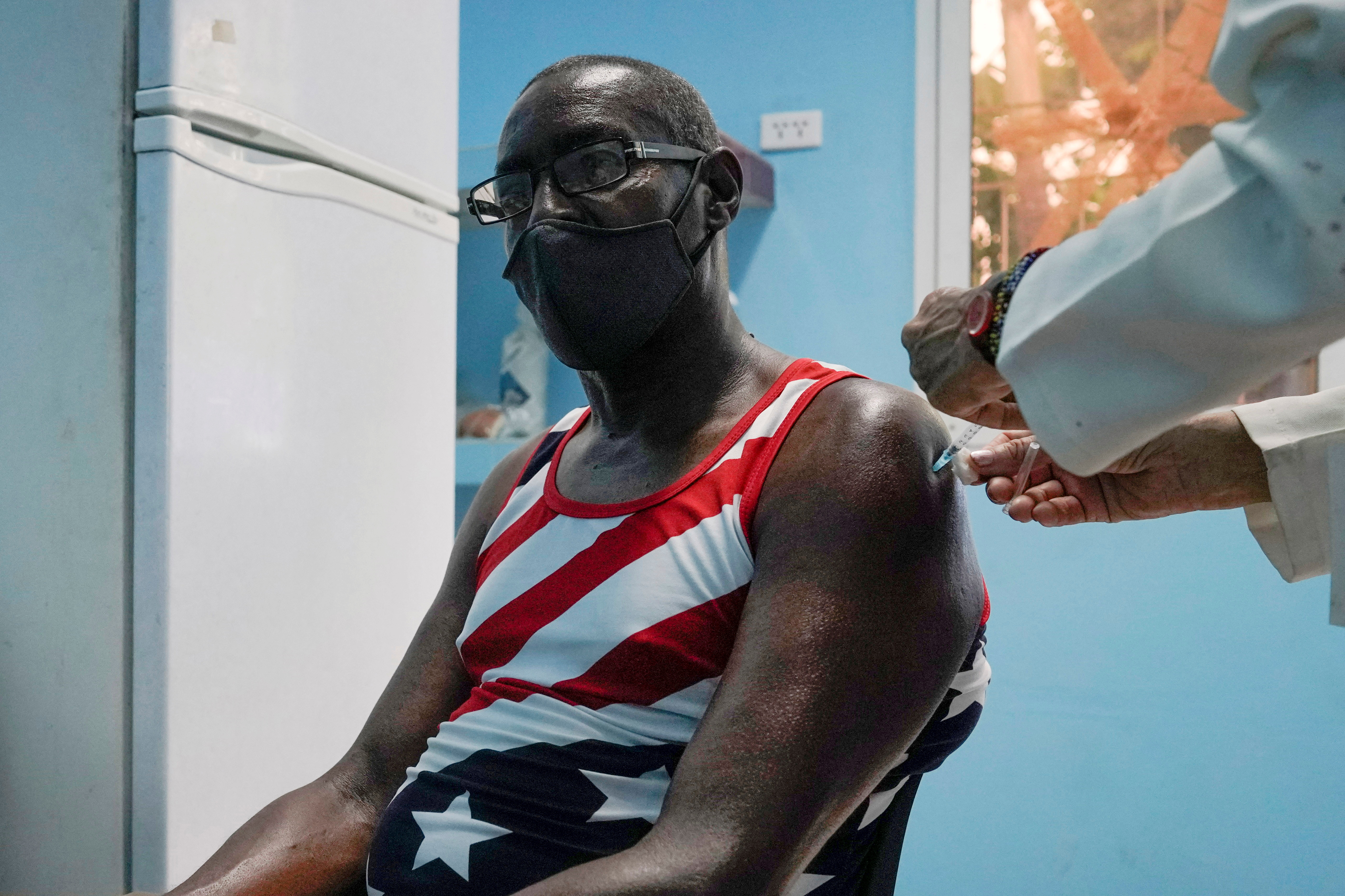 A man is vaccinated at a vaccination center amid concerns about the spread of the coronavirus disease (COVID-19) in Havana, Cuba, June 17, 2021. REUTERS/Alexandre Meneghini/File Photo