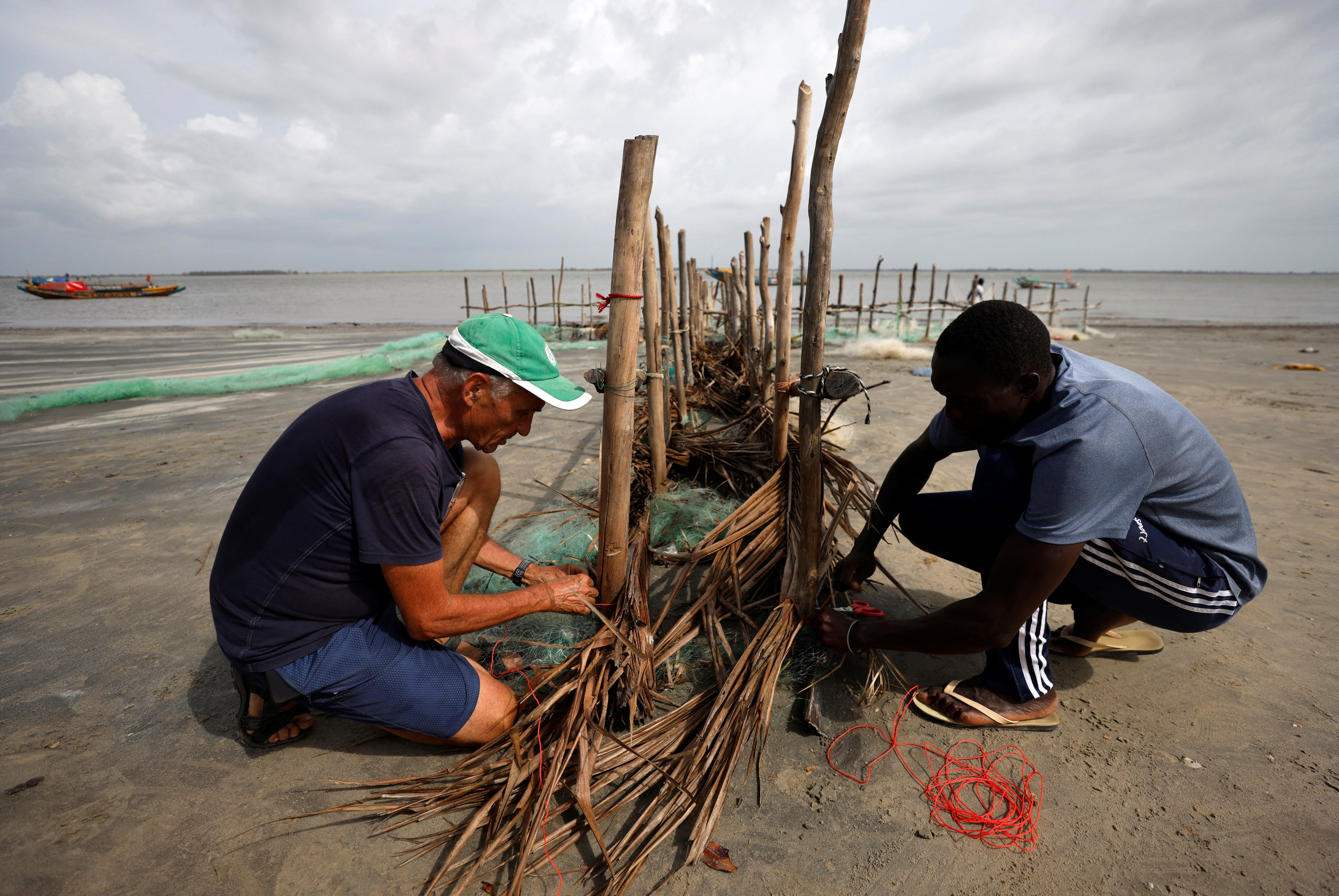 Senegalese island keeps coastal erosion at bay with stakes in the sand