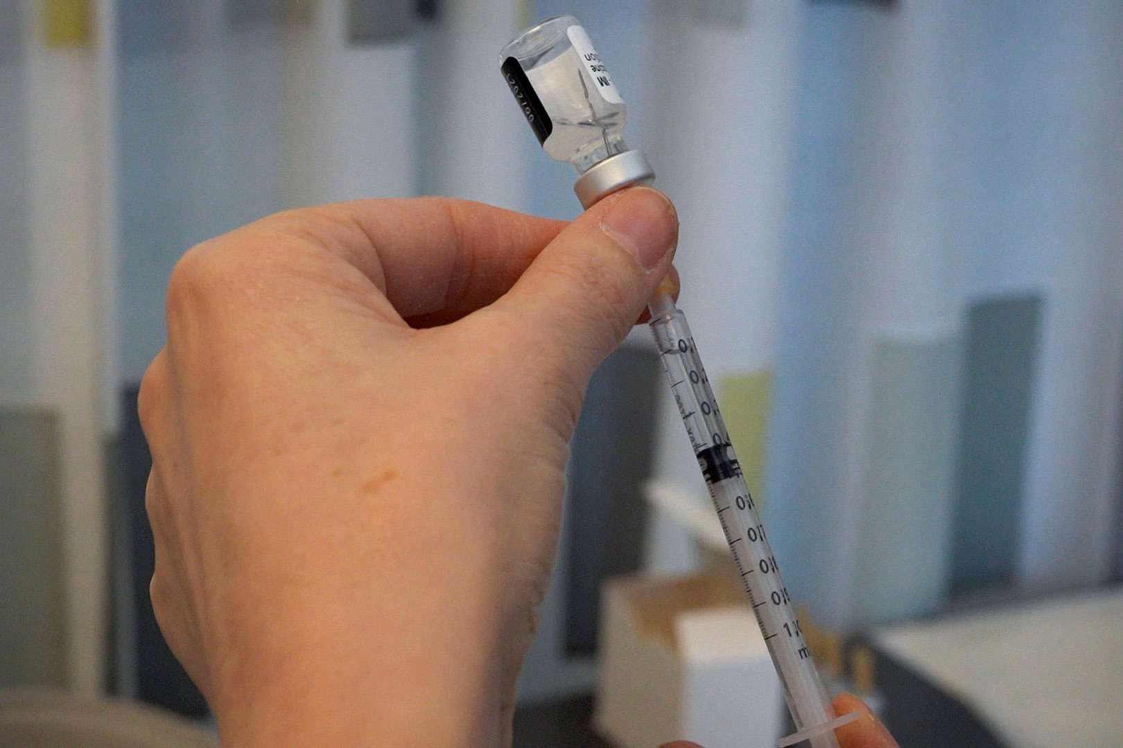 Nurse Roos prepares a dose of vaccine against coronavirus disease (COVID-19) in Helsinki