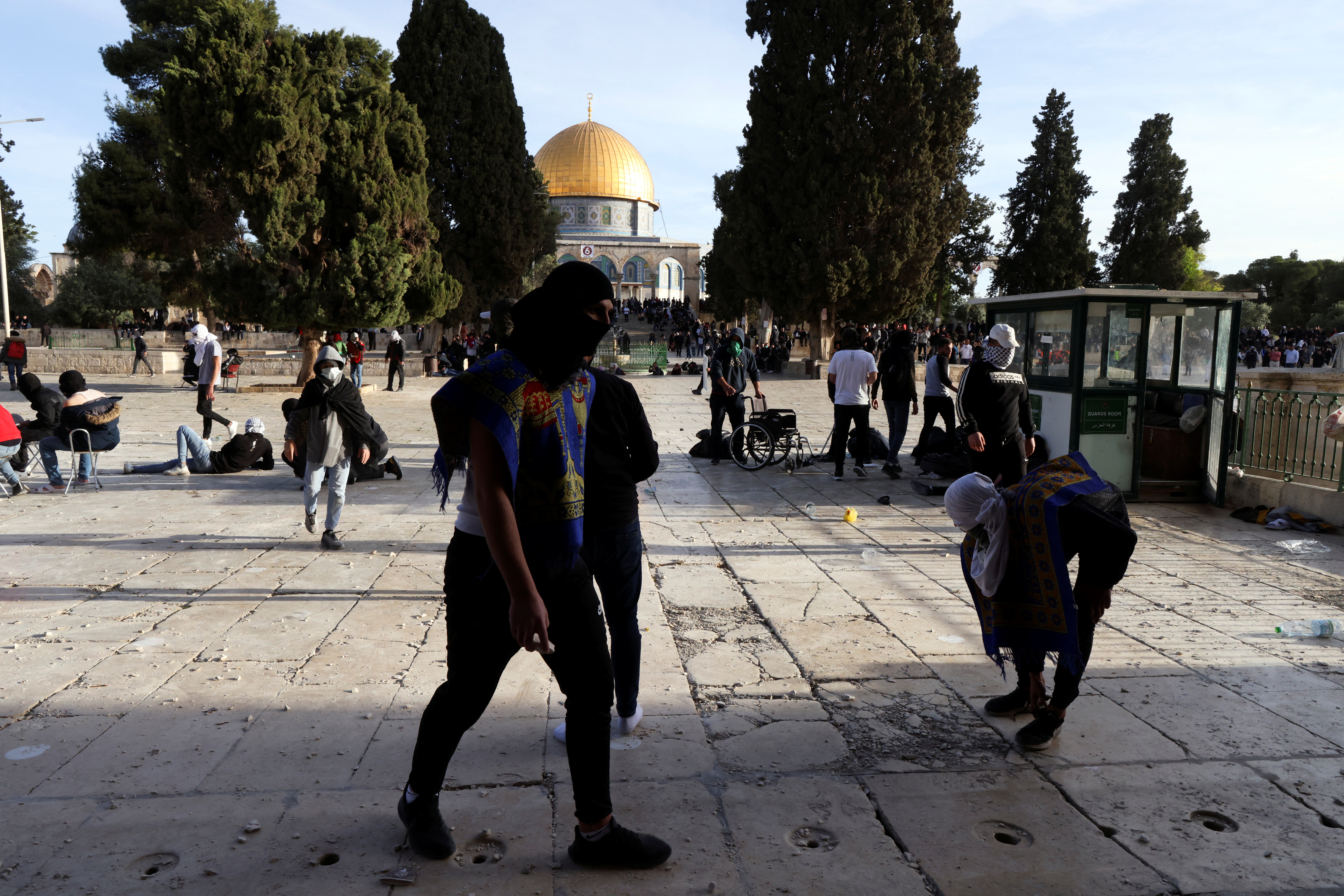 Palestinian protestors walk around during clashes with Israeli security forces at the compound that houses Al-Aqsa Mosque, known to Muslims as Noble Sanctuary and to Jews as Temple Mount, in Jerusalem's Old City