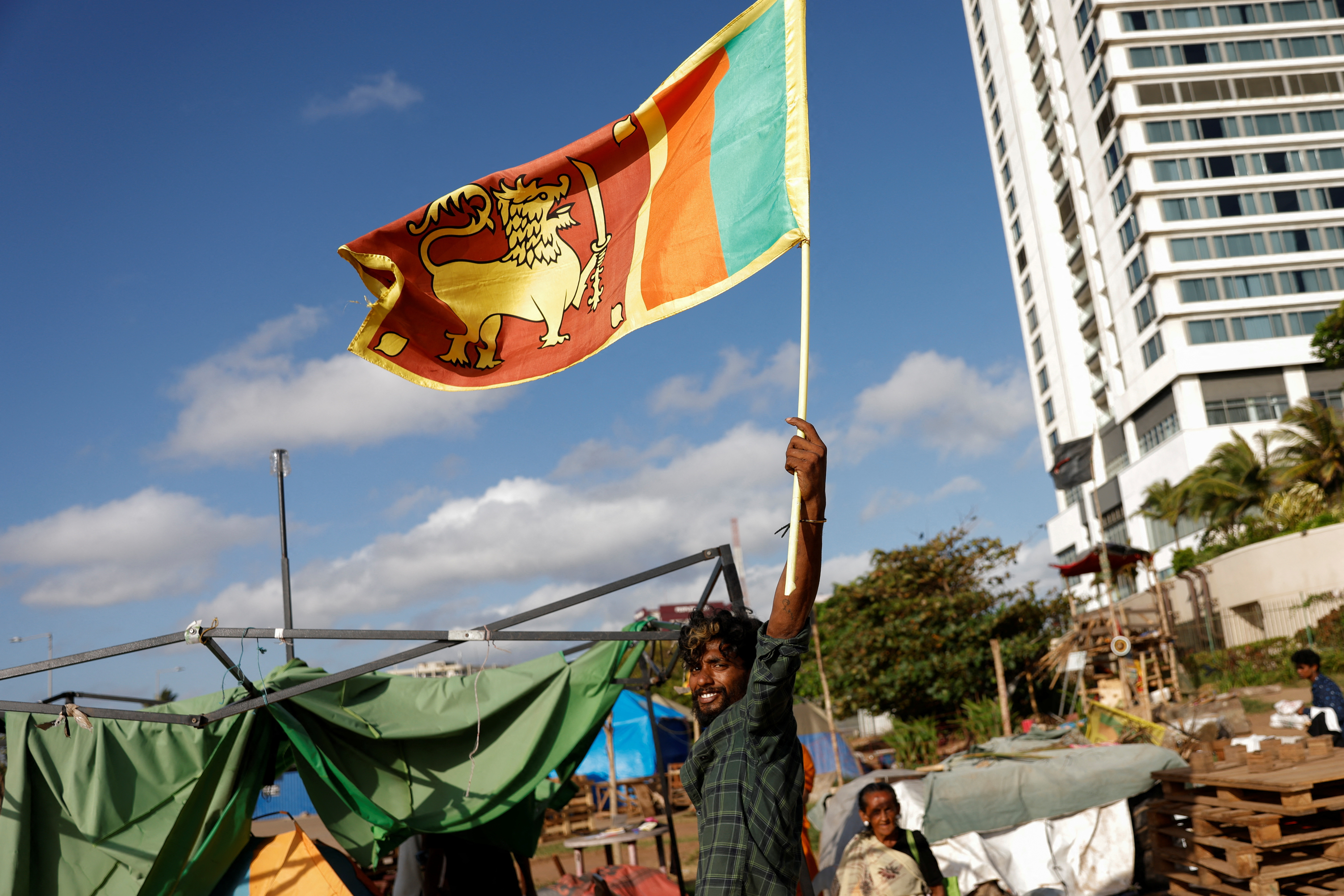 Protesters leave from a seafront tent camp in Colombo