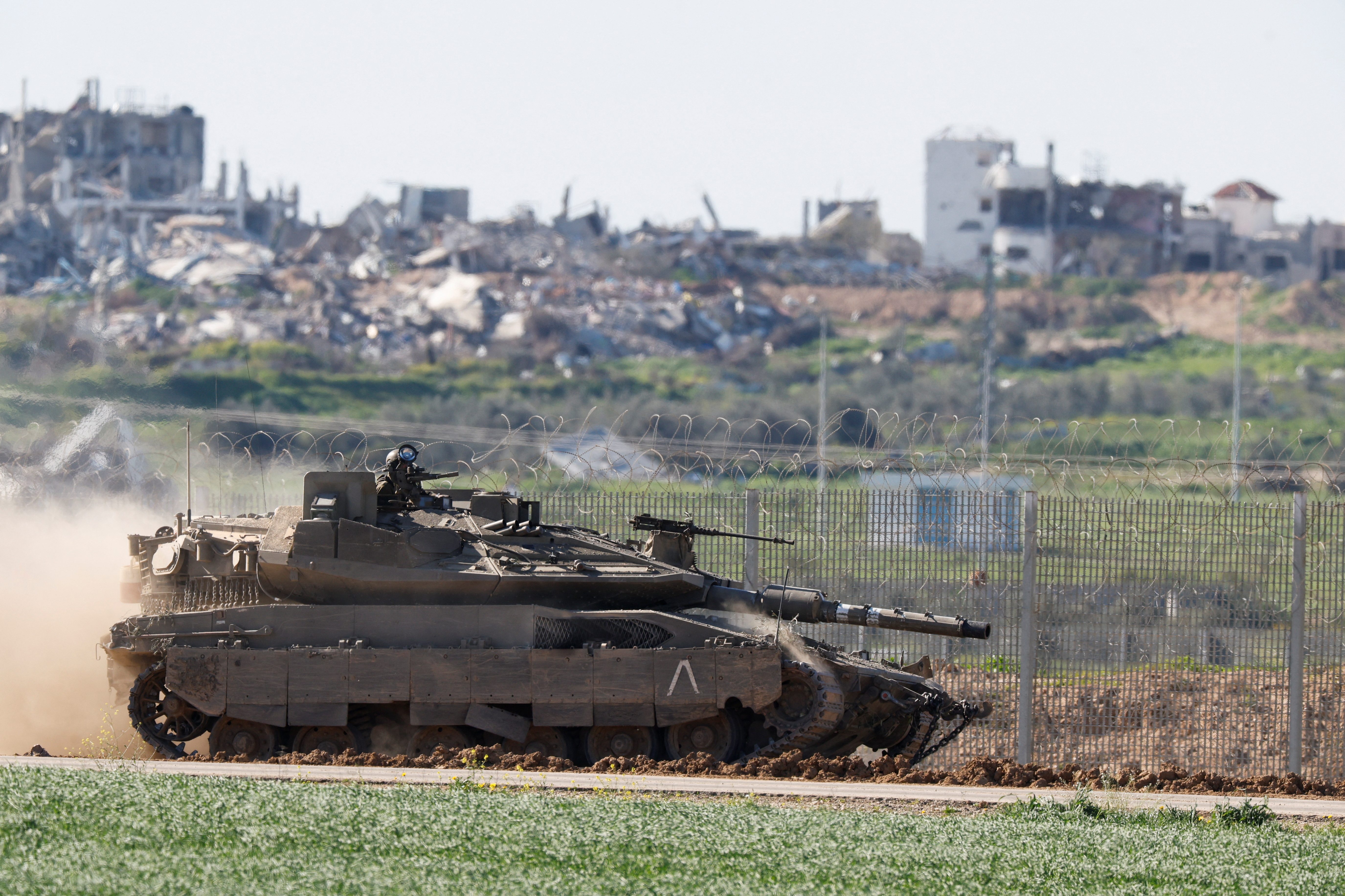 Israeli army vehicles return from the Gaza strip, in southern Israel