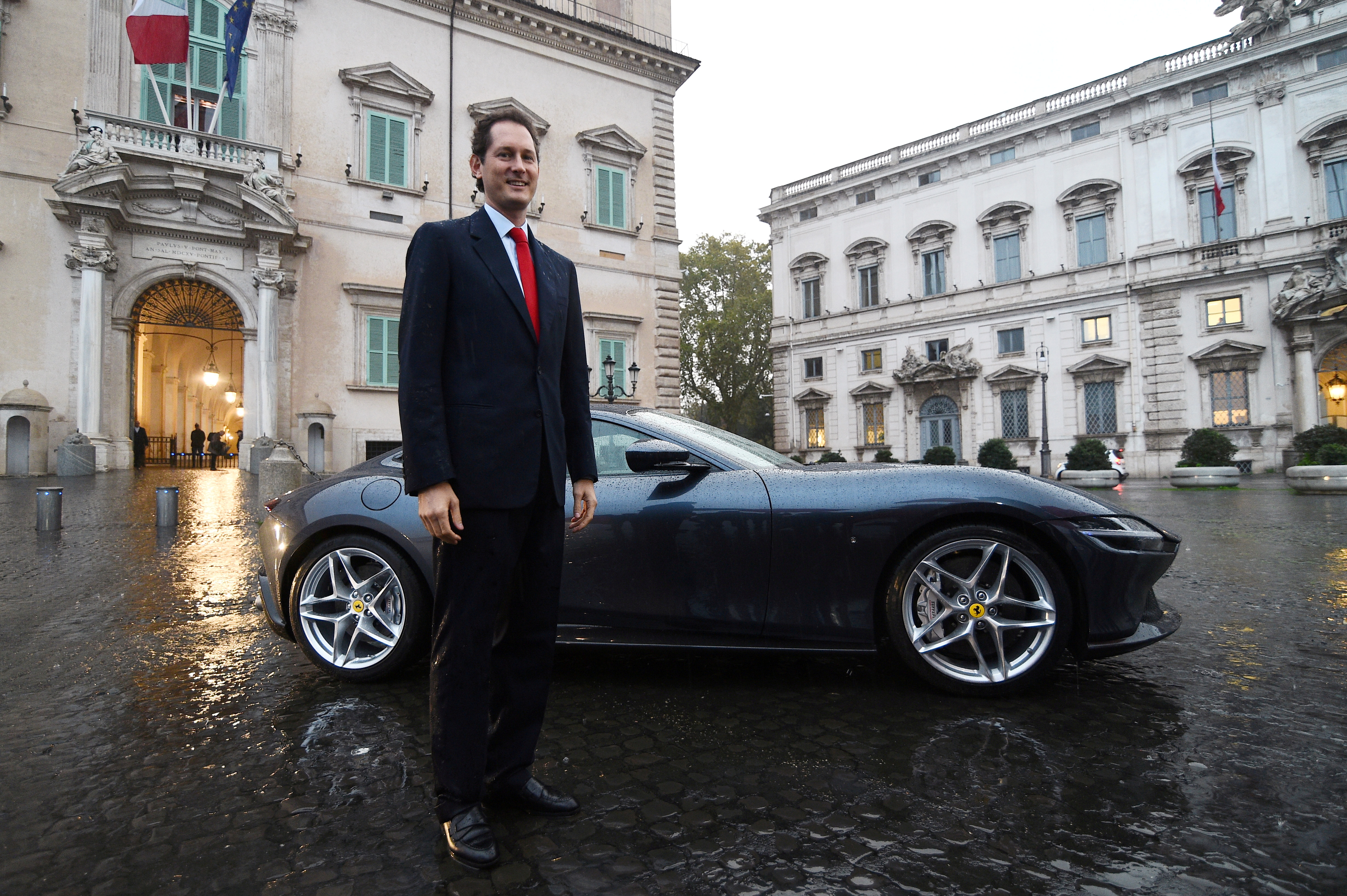 Fiat Chrysler chairman John Elkann poses next to the new Ferrari Roma outside the Quirinale Presidential Palace in Rome
