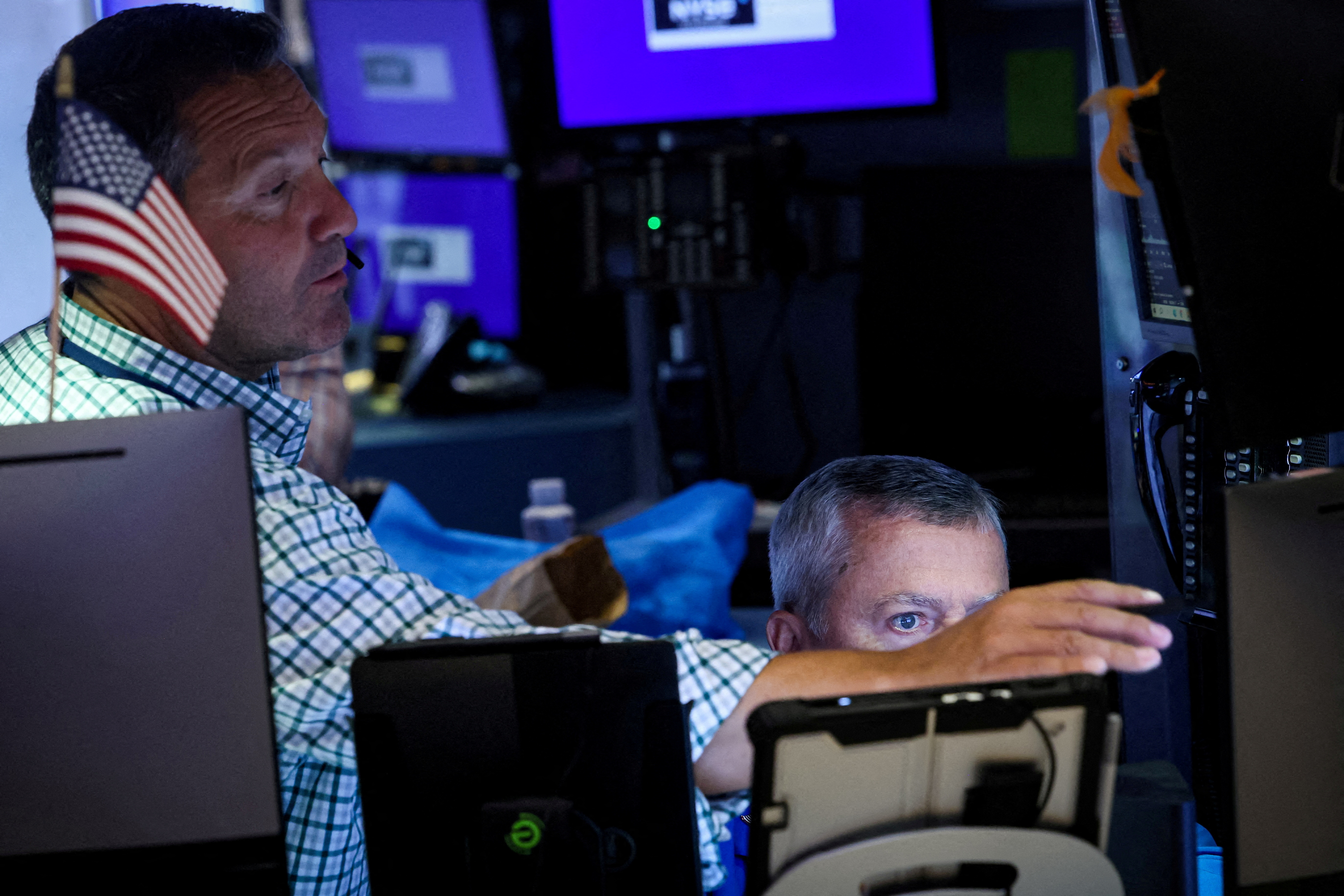 Traders work on the floor of the NYSE in New York