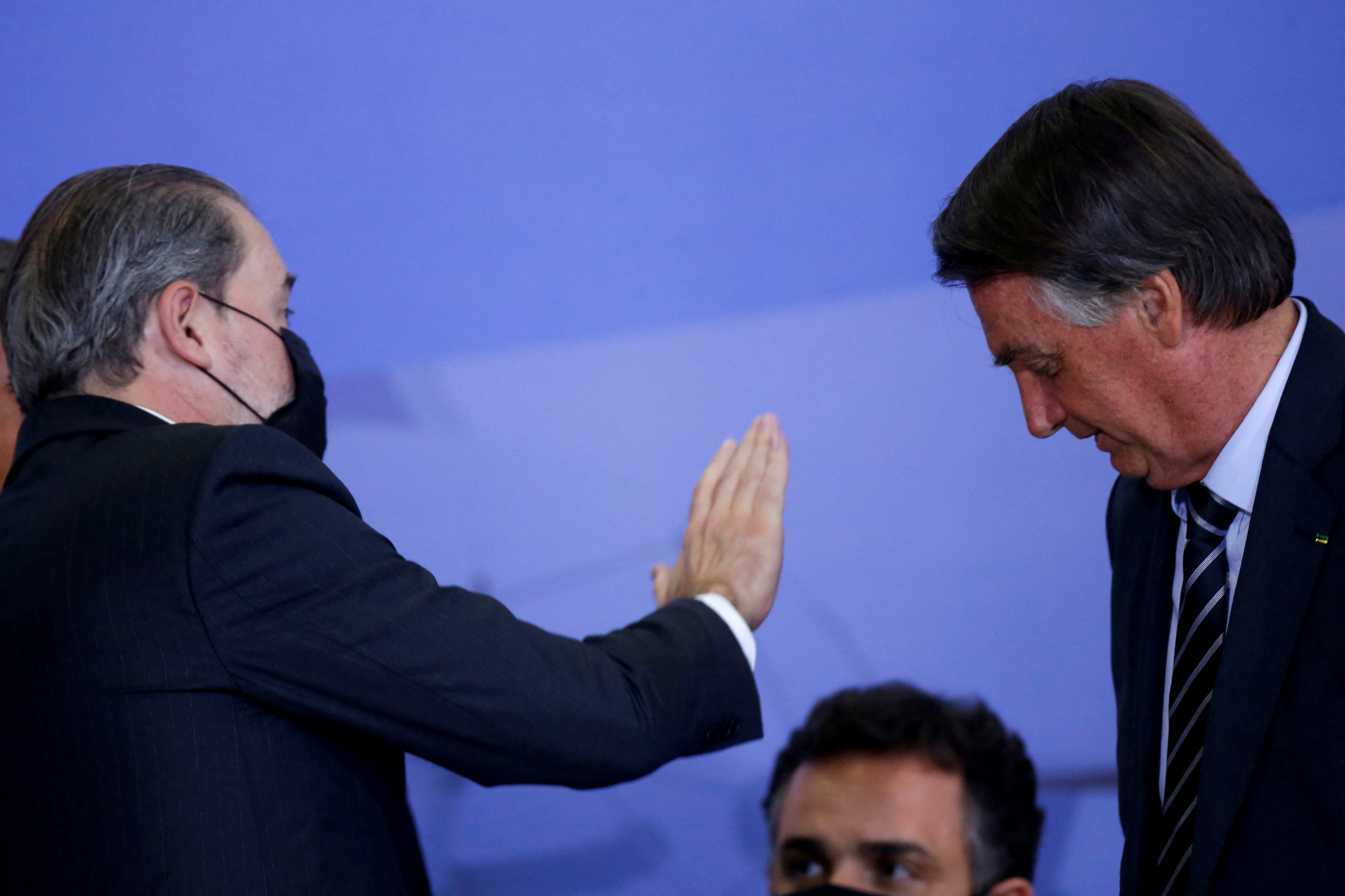 Brazil's Supreme Federal Court Judge Toffoli gestures towards Brazil's President Bolsonaro during a ceremony in Brasilia