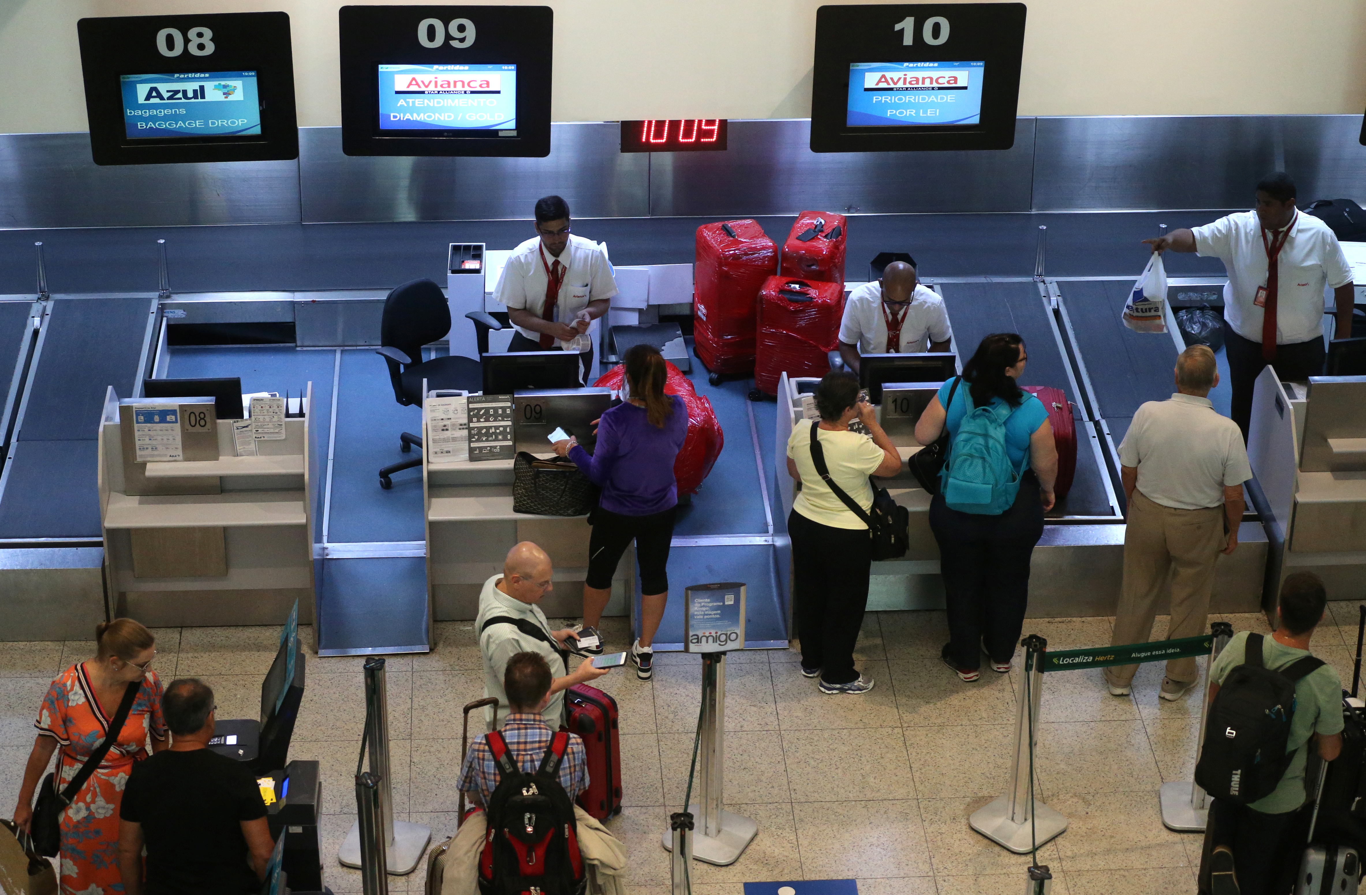 Passengers are seen as they check in at the counters of airlines Avianca and Azul at Santos Dumont airport in Rio de Janeiro