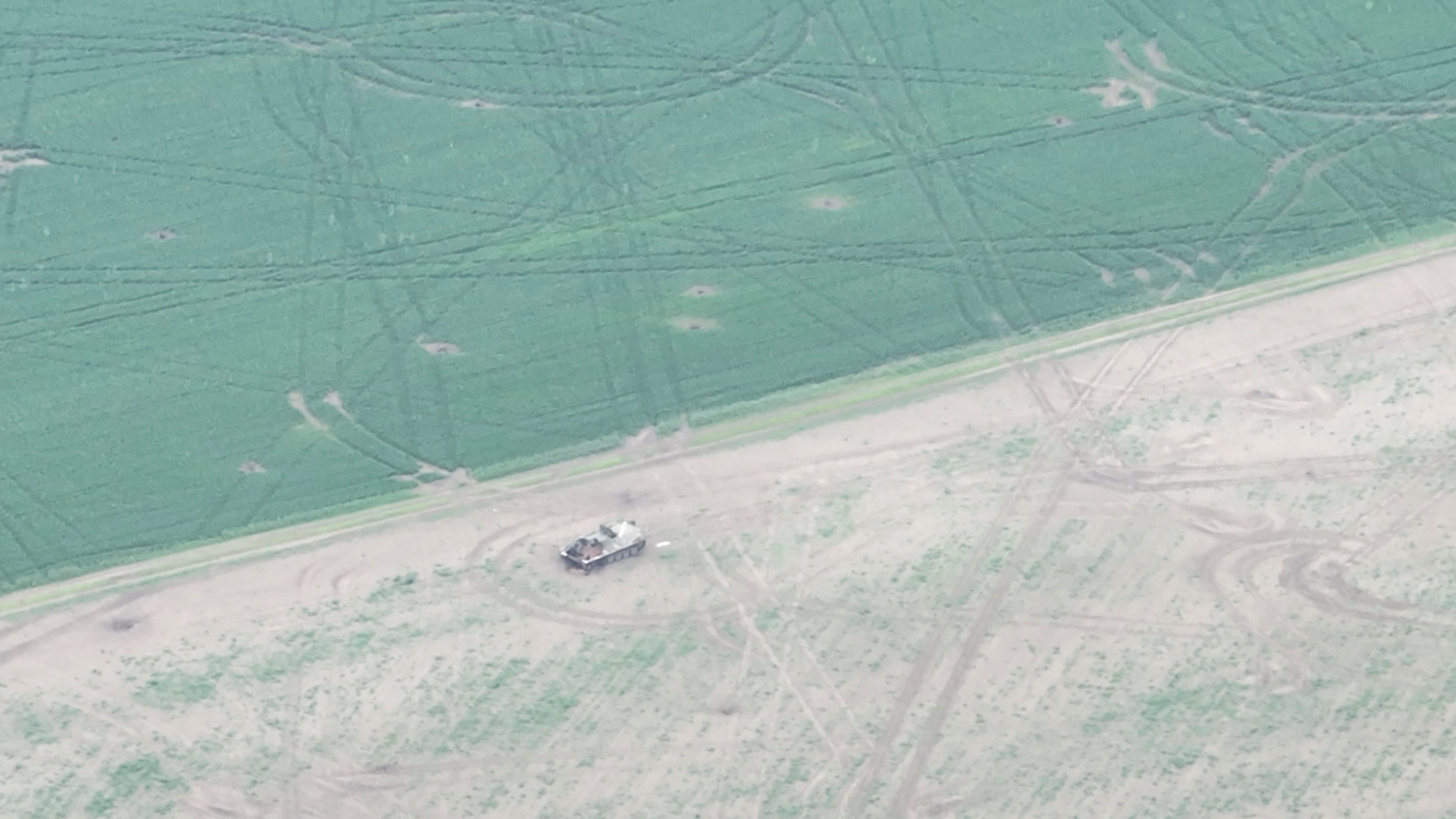 Drone footage shows a military vehicle in a field in Oleksandrivka, Kherson region