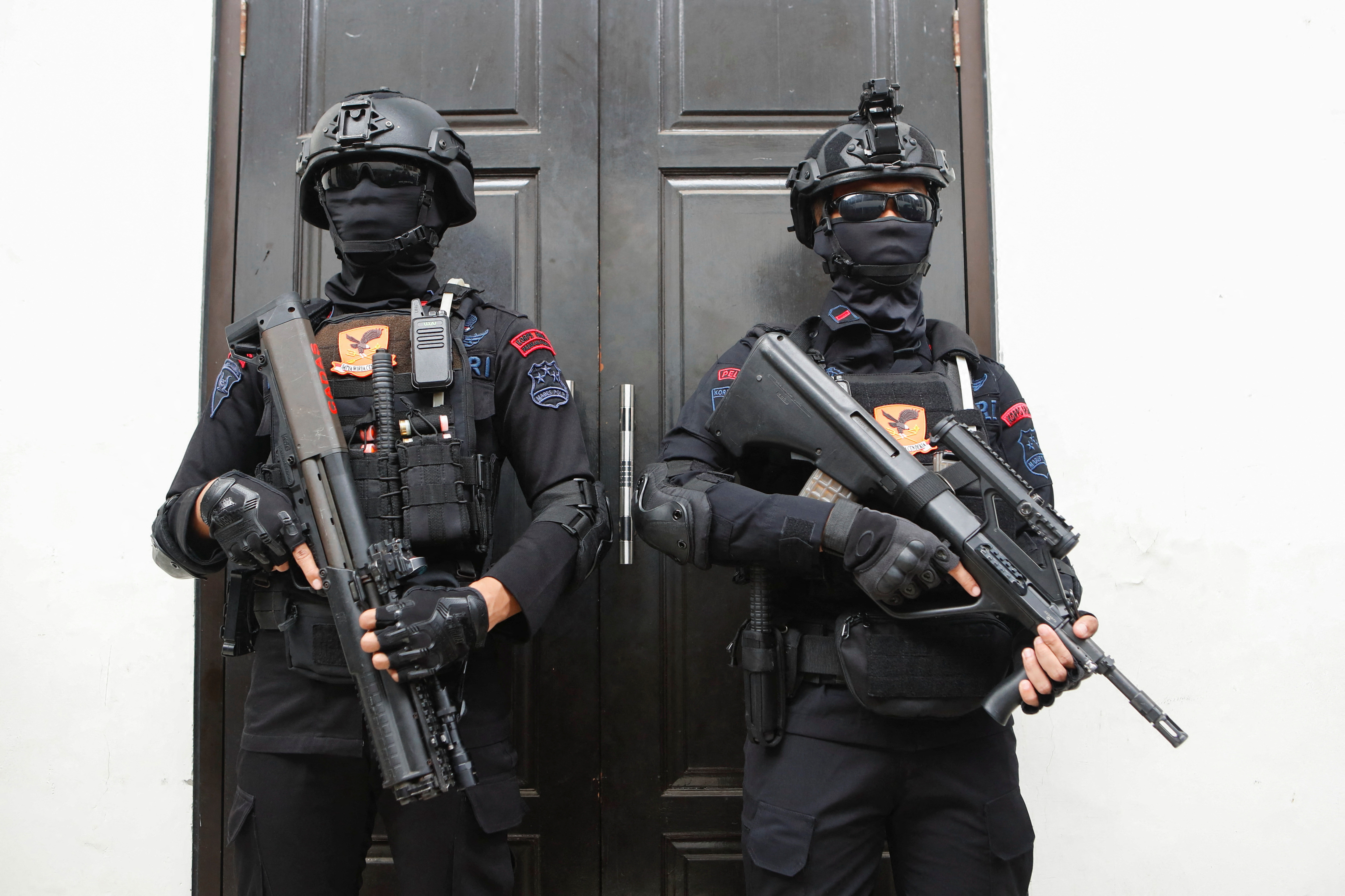 Riot police officers stand guard during the trial of Ferdy Sambo, a former Indonesian police general accused in a murder case at South Jakarta District Court