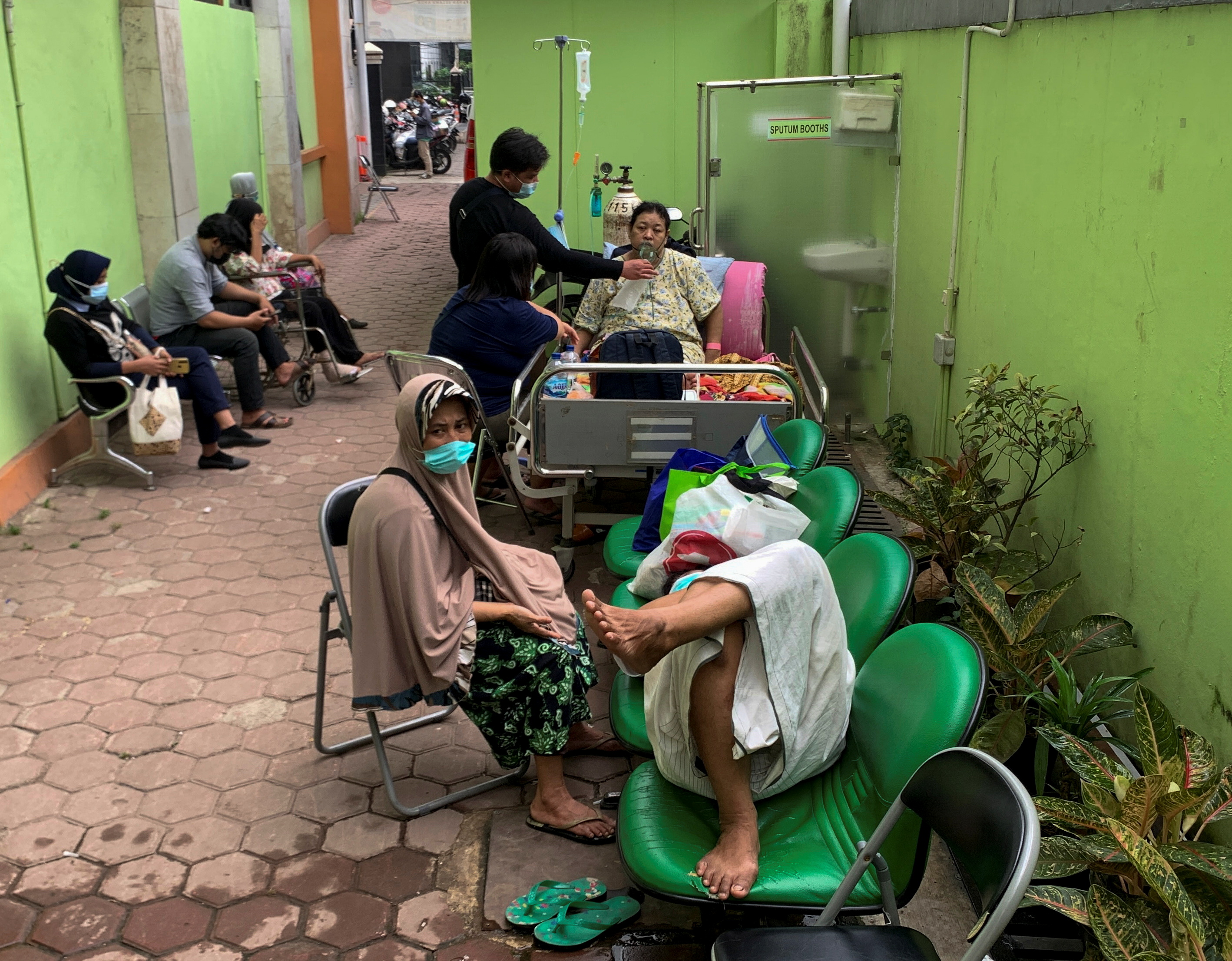 Patients with breathing problem are seen outside the emergency ward at a government-run hospital, as the coronavirus disease cases surges, in Jakarta