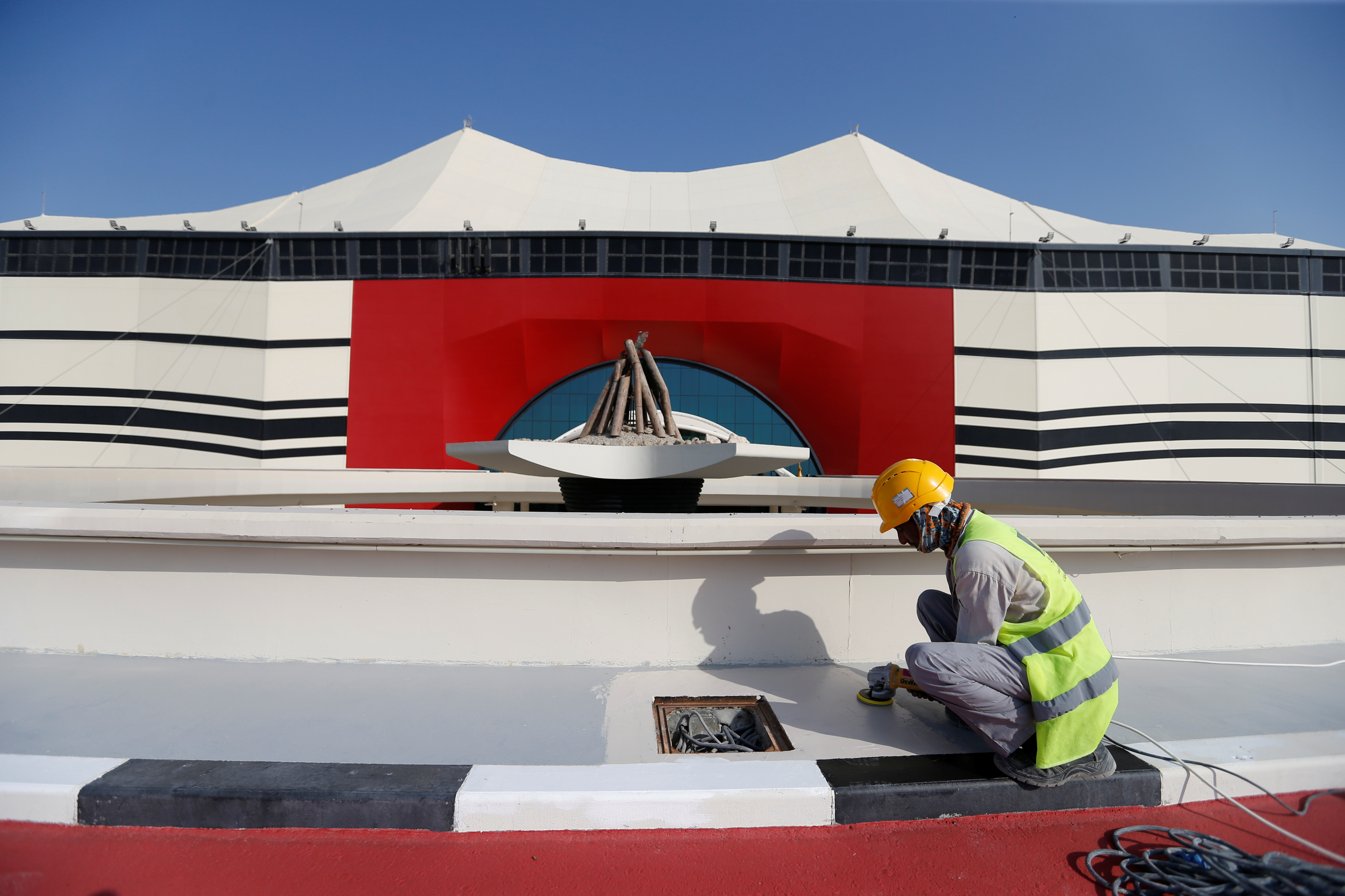 A worker puts final touches at Al Bayt Stadium, one of the venues of the Qatar World Cup 2022, in Al Khor