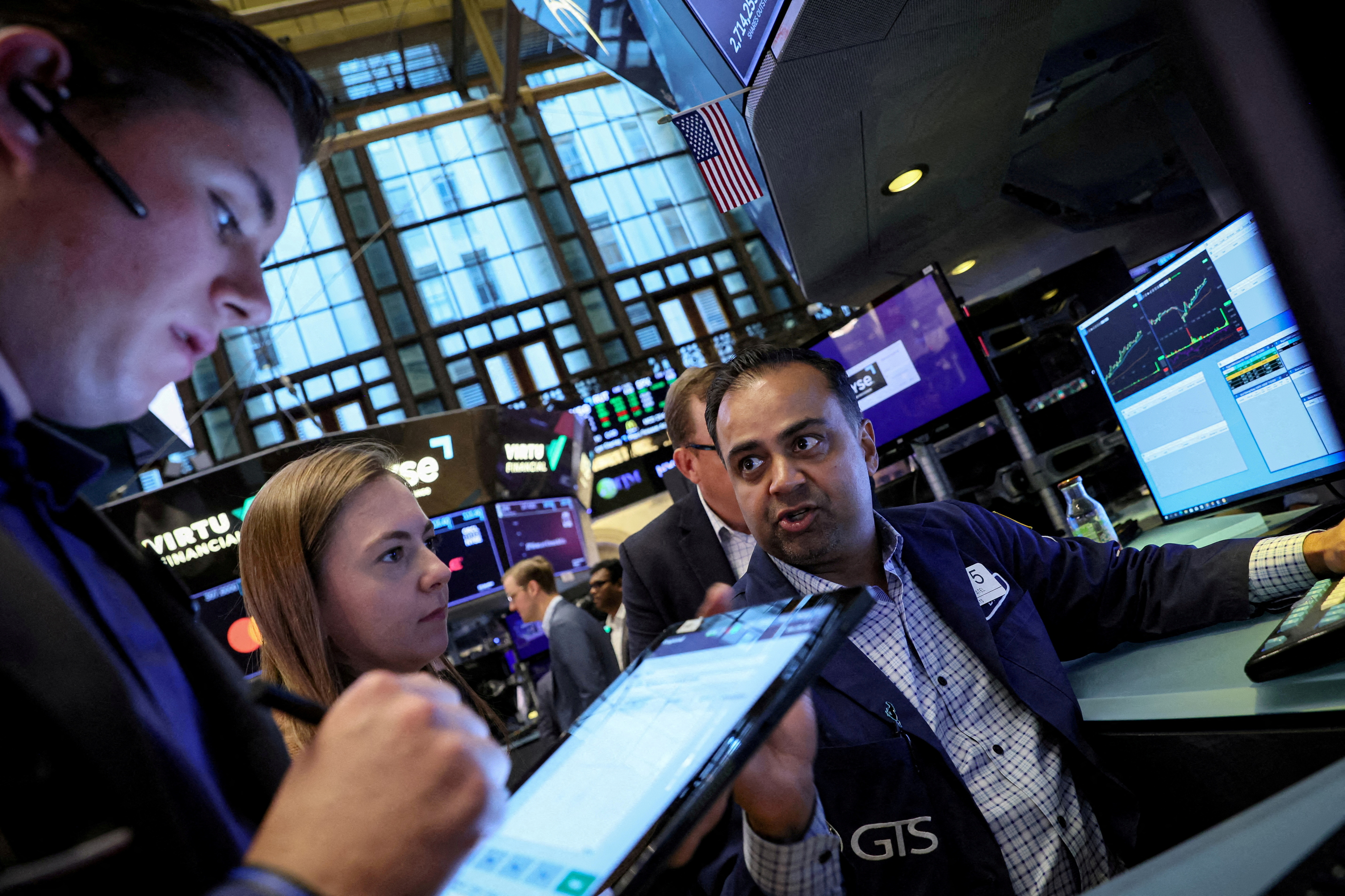 Traders work on the floor of the NYSE in New York