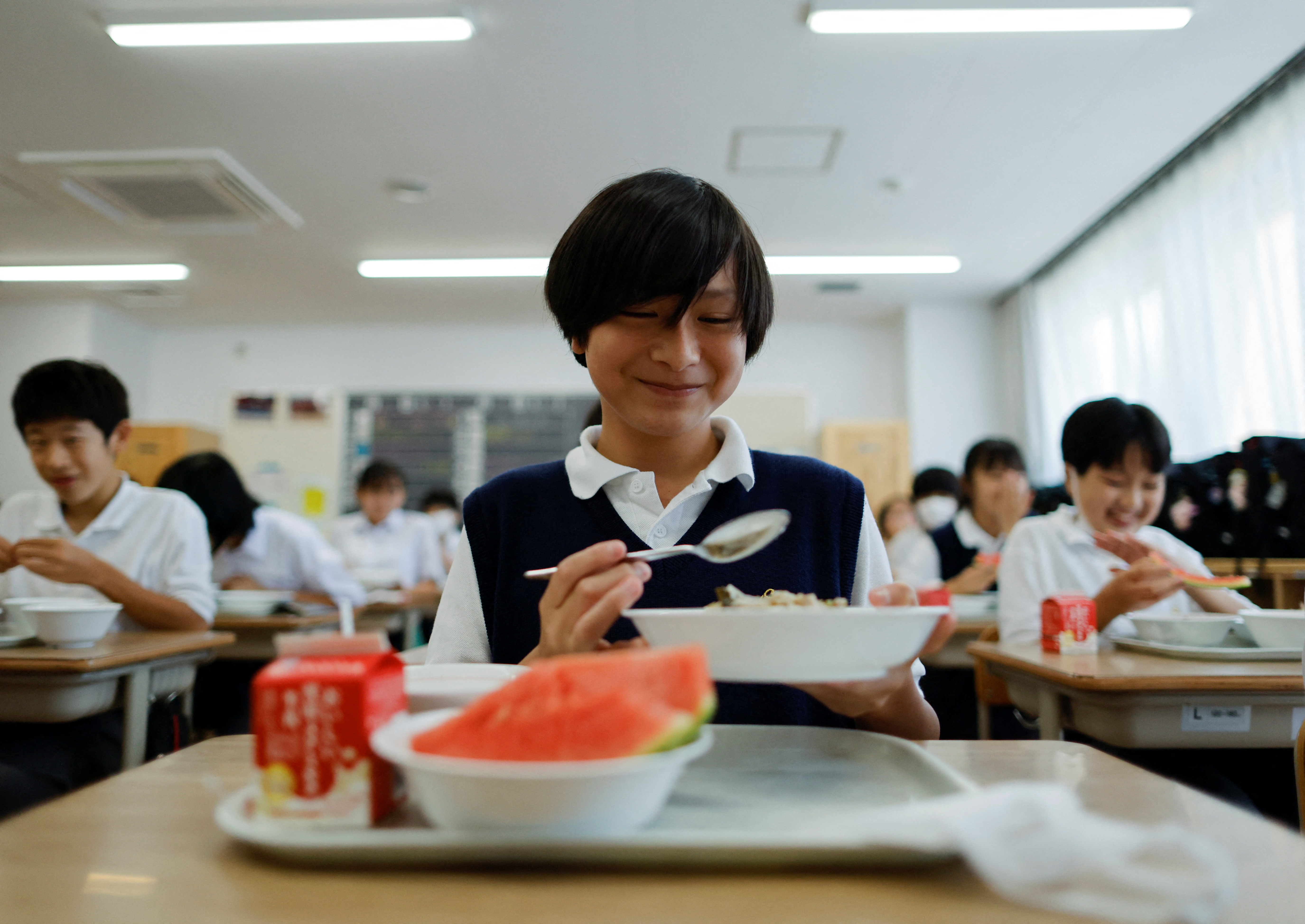Students take a school lunch at Senju Aoba Junior High School in Tokyo