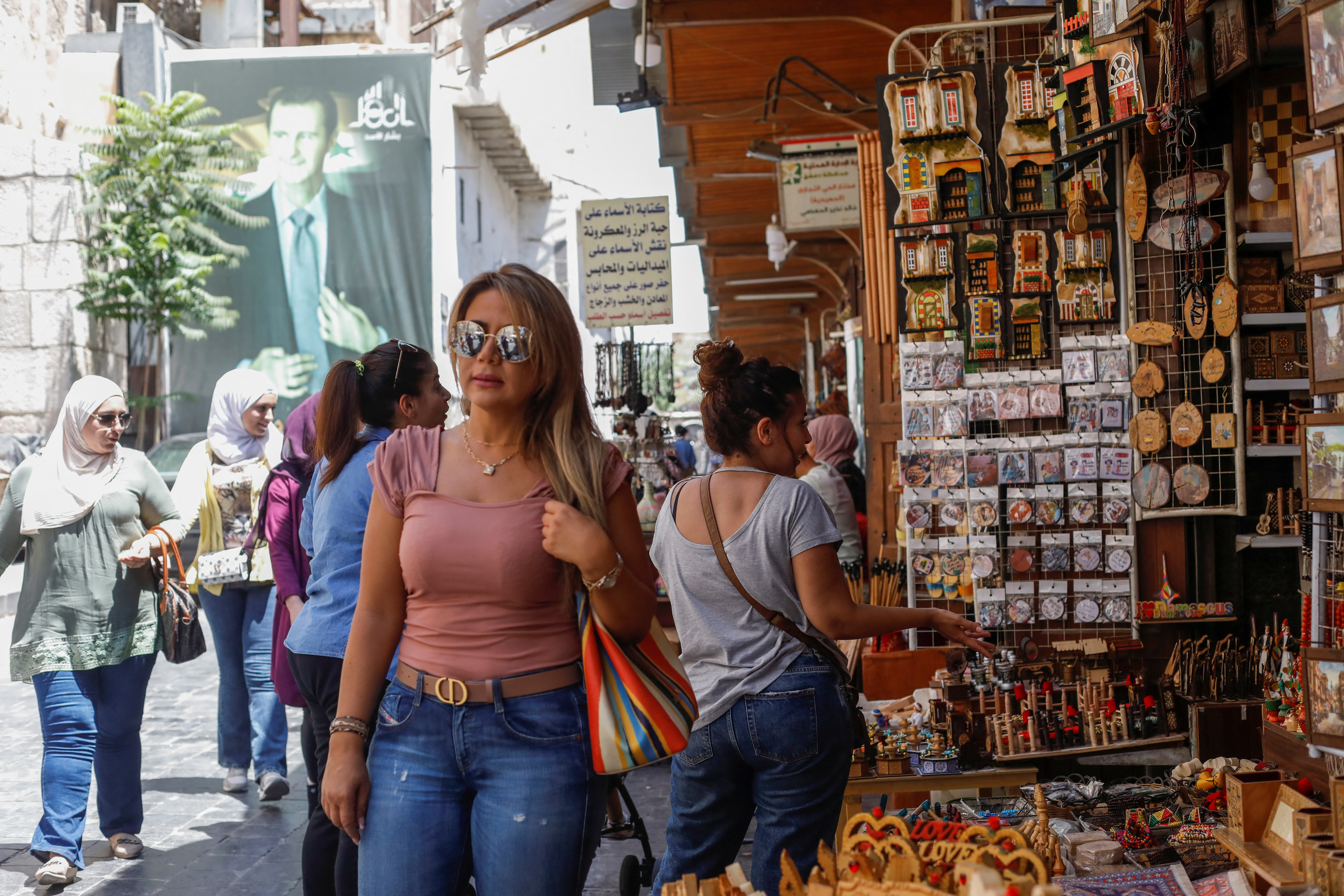 Rana al-Daieh, a Syrian expatriate who lives in Dubai, stands near a souvenir shop in Damascus