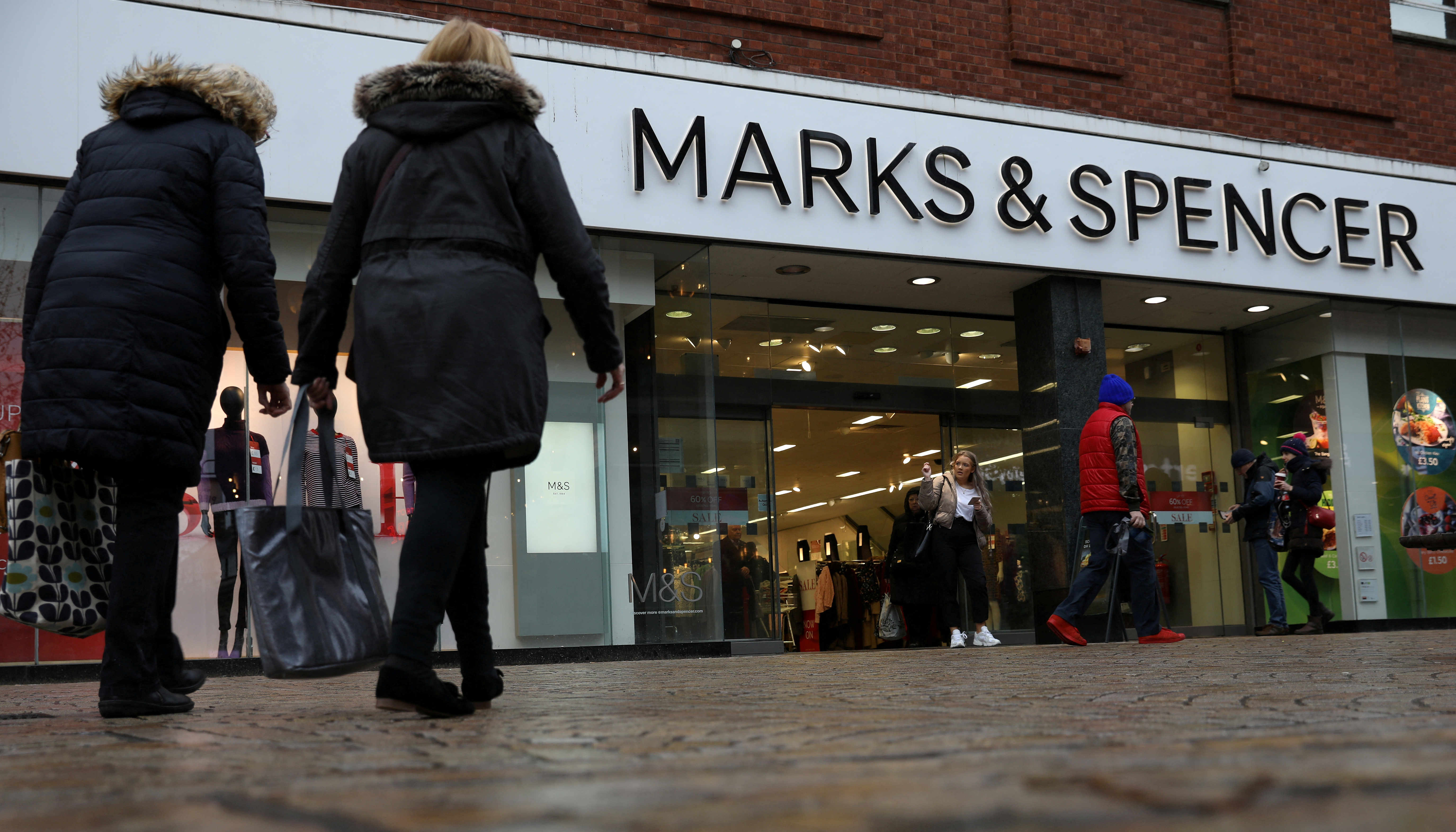 Shoppers walk past a branch of Marks & Spencer in Altrincham, Britain