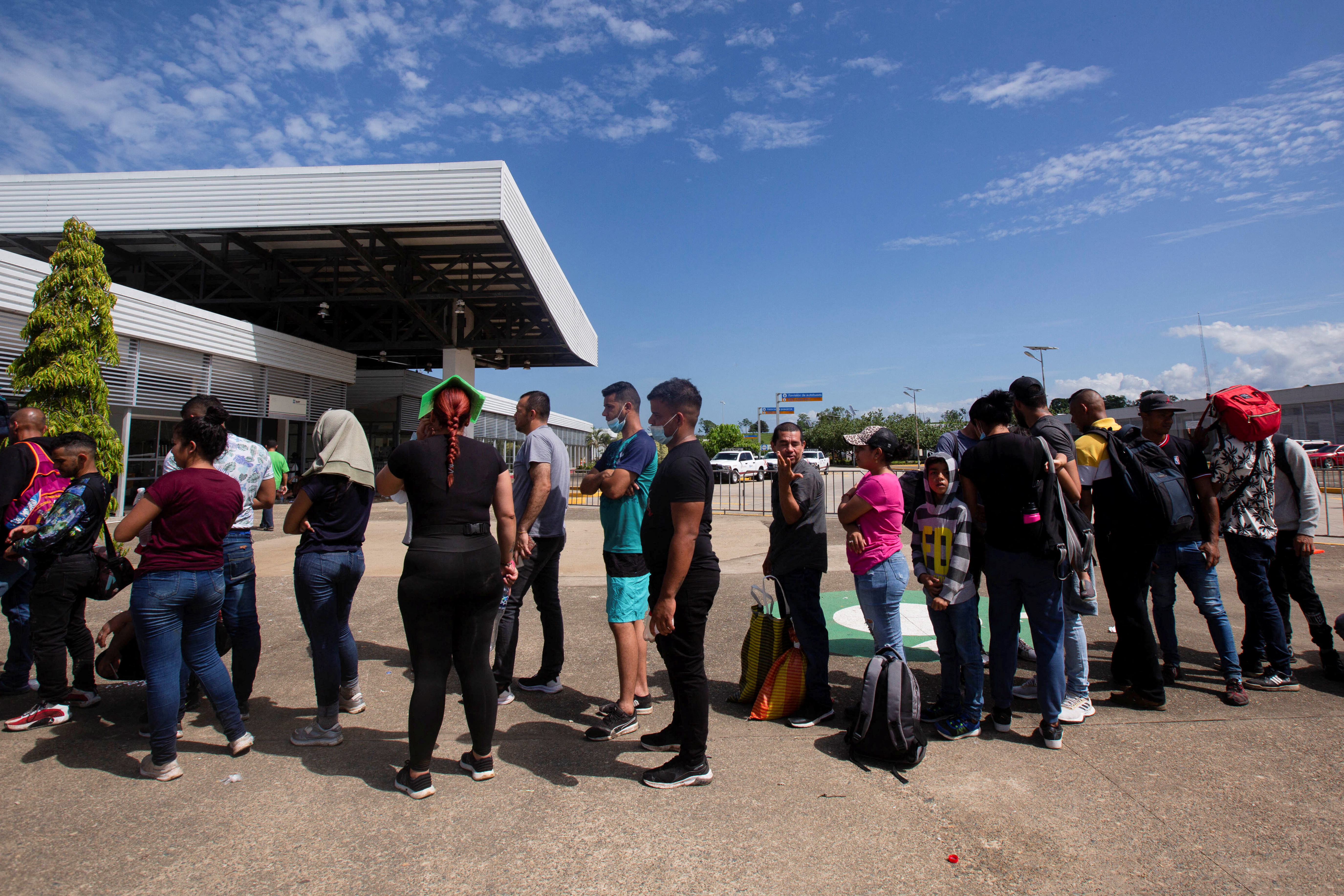 Migrants queue an to get documents to cross the country towards the U.S. border, at an office of the National Institute of Migration in Huixtla