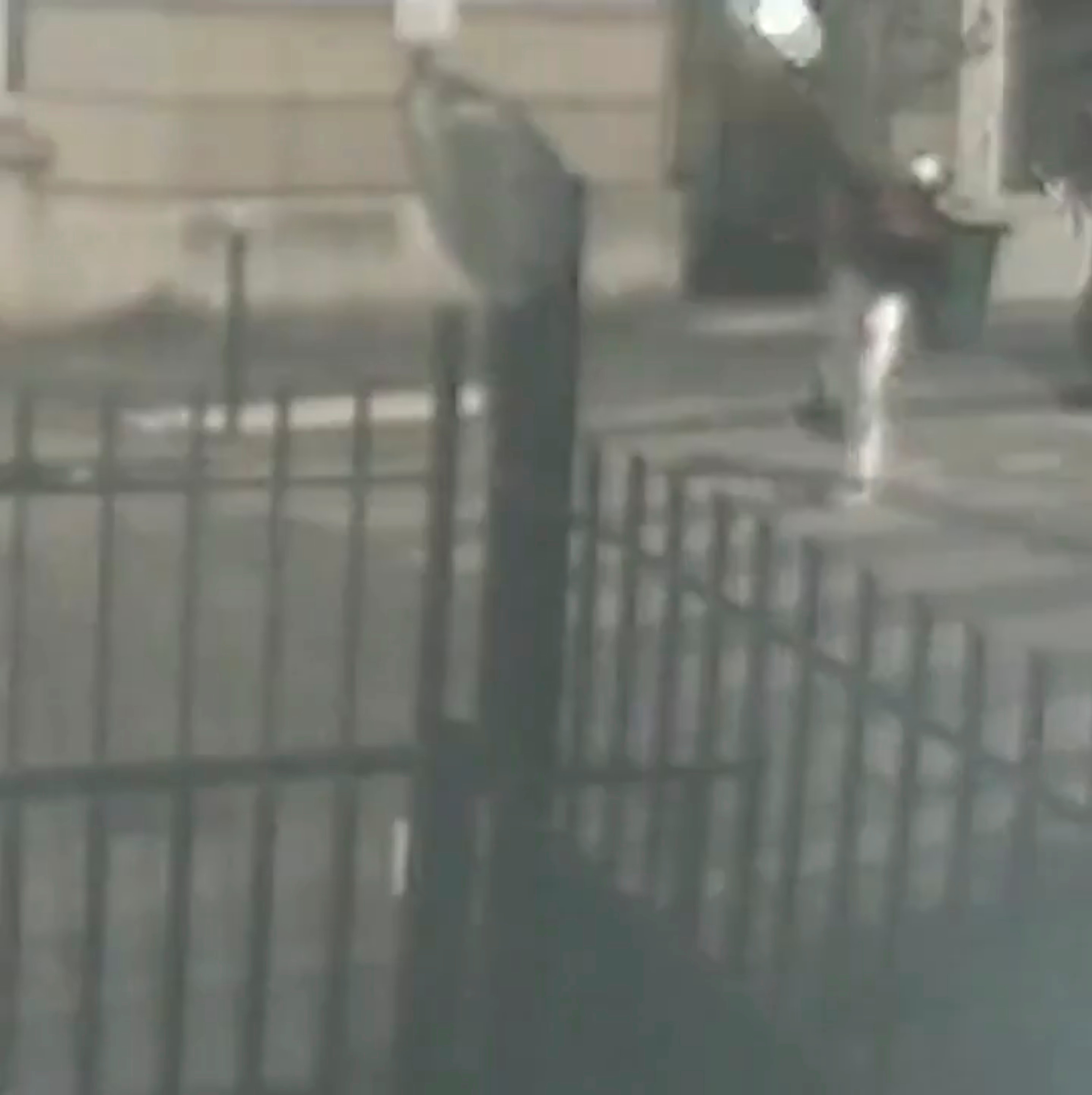 A person throws a petrol bomb at the Cuban embassy in Paris, France July 26, 2021, in this screen grab obtained from a video. Video recorded July 26, 2021. TWITTER @CUBAMINIREX/Handout via REUTERS