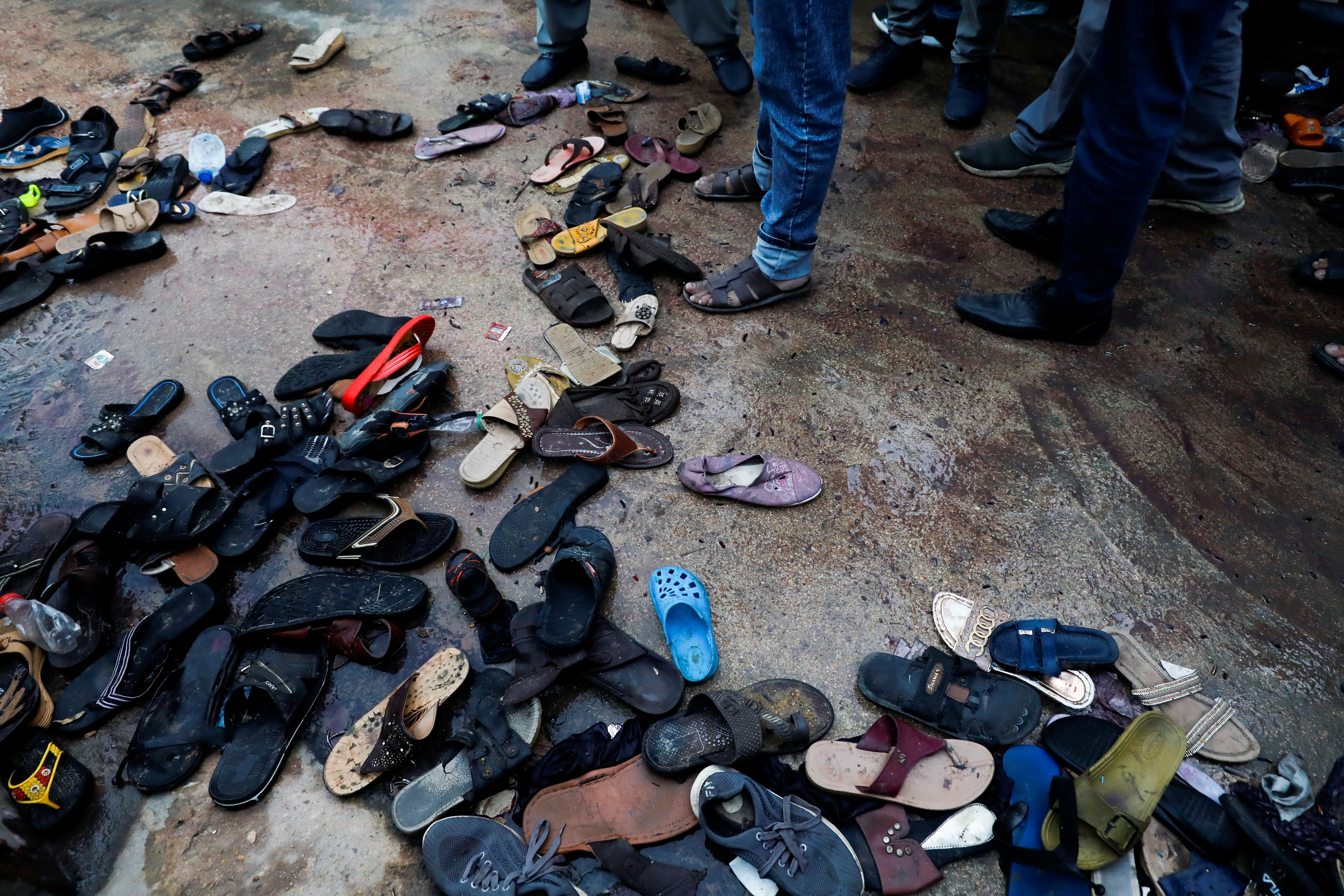 A view of a site with a pile of footwear after a stampede occurred during handout distribution, in Karachi