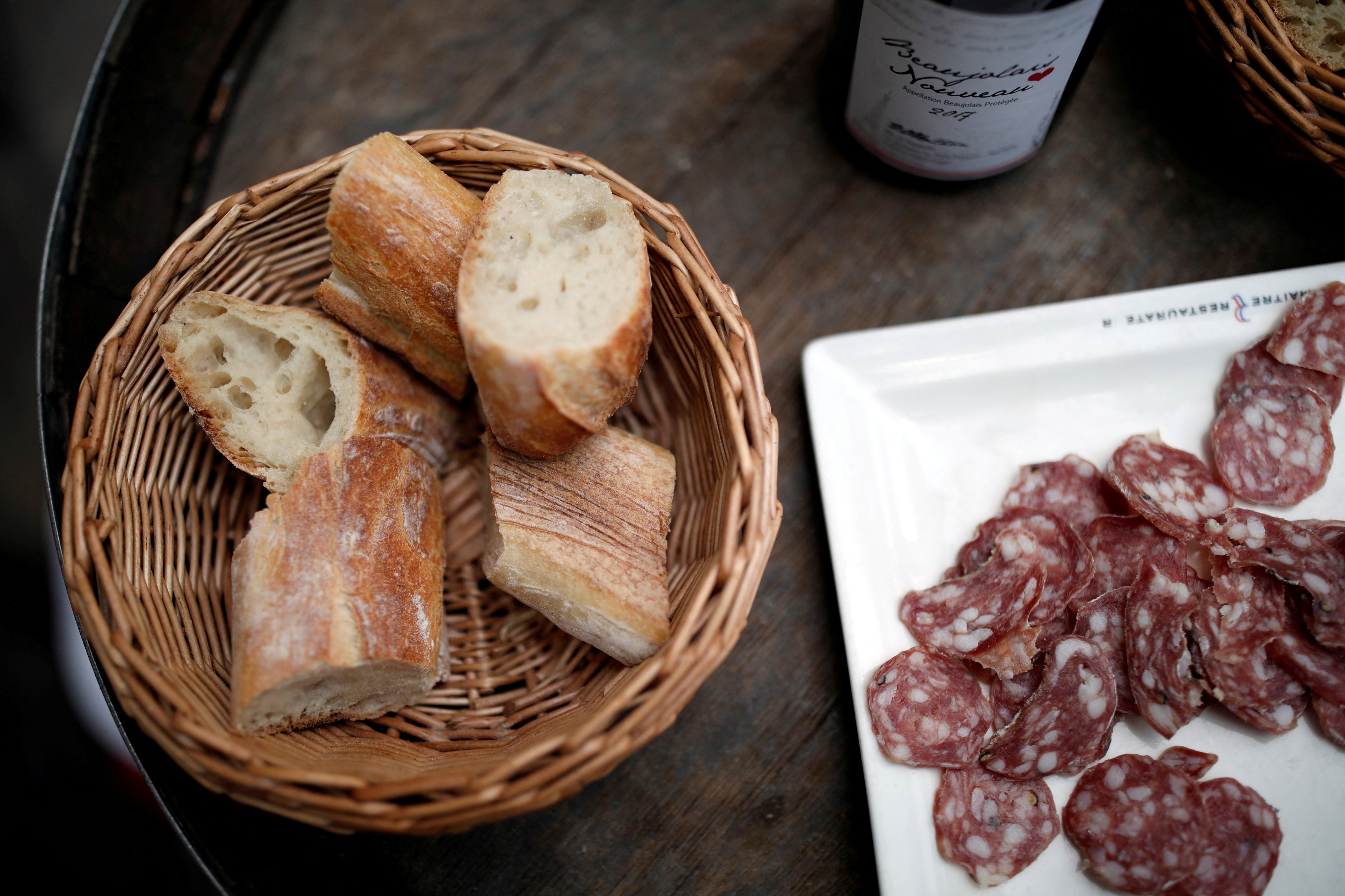 Pieces of French baguette and sausage are seen in a bistrot in Paris