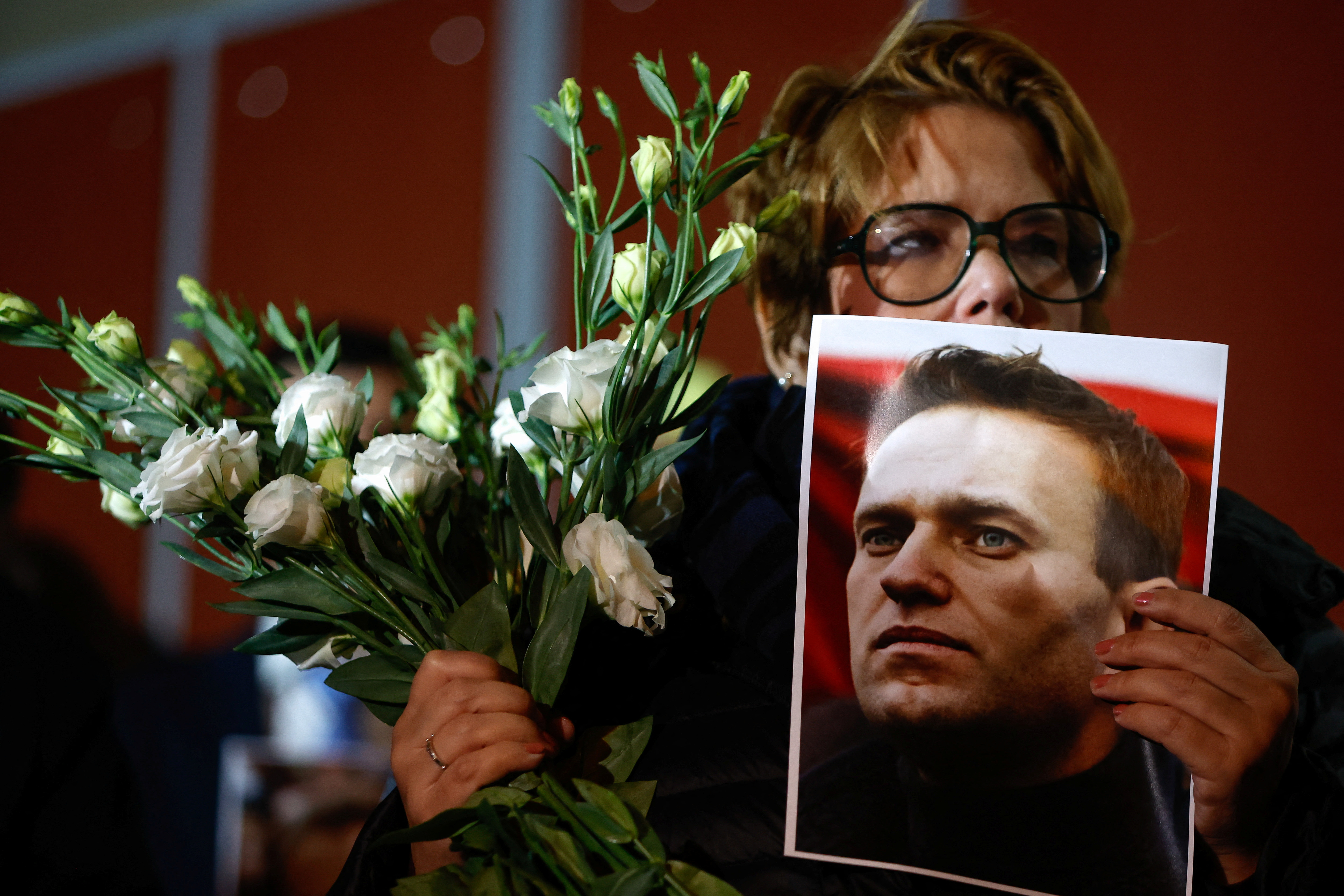 People attend a protest and vigil following the death of Russian opposition leader Alexei Navalny, in Kappara