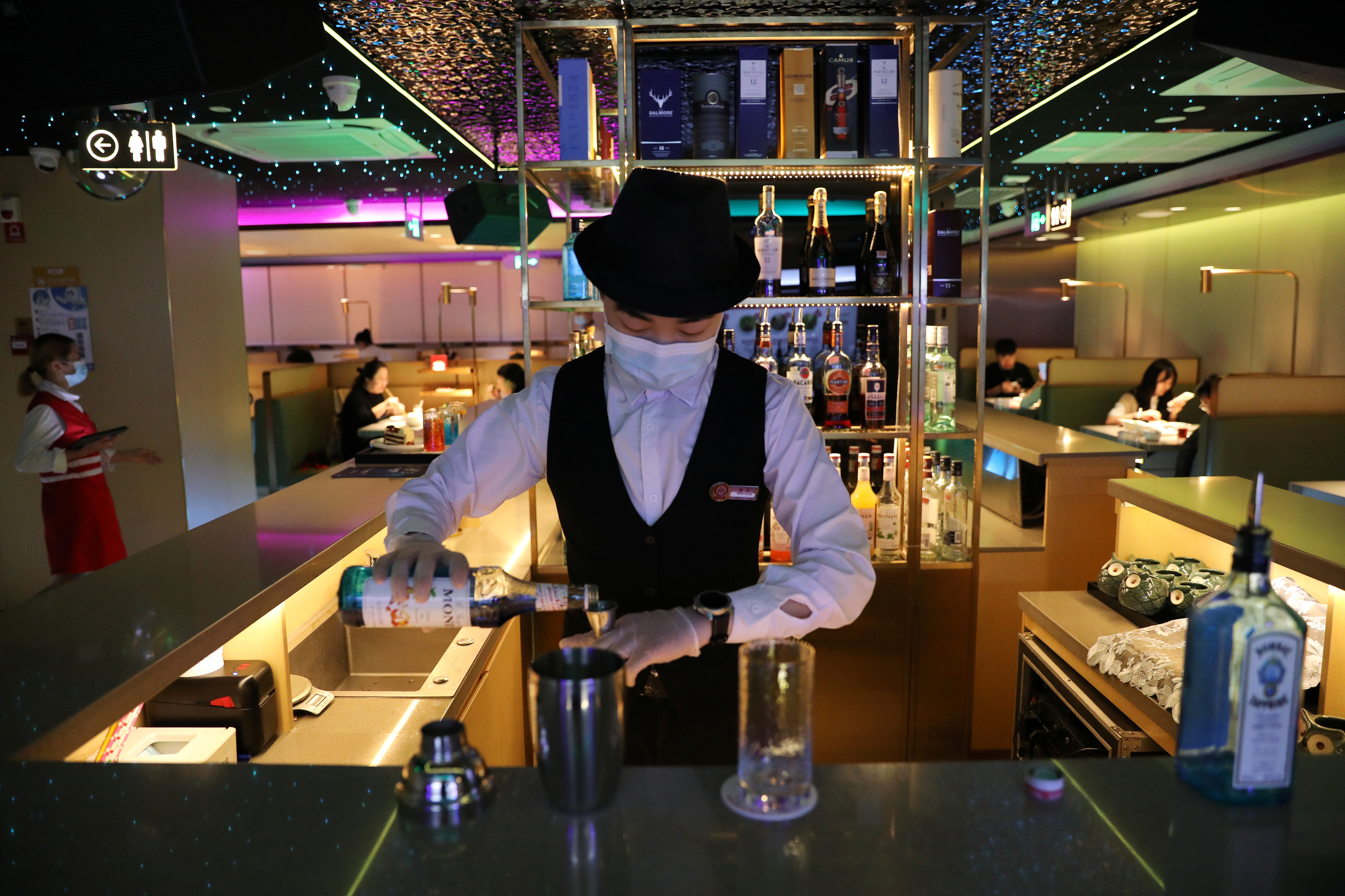 Bartender prepares a drink at a bar section inside a Haidilao hotpot restaurant in Beijing