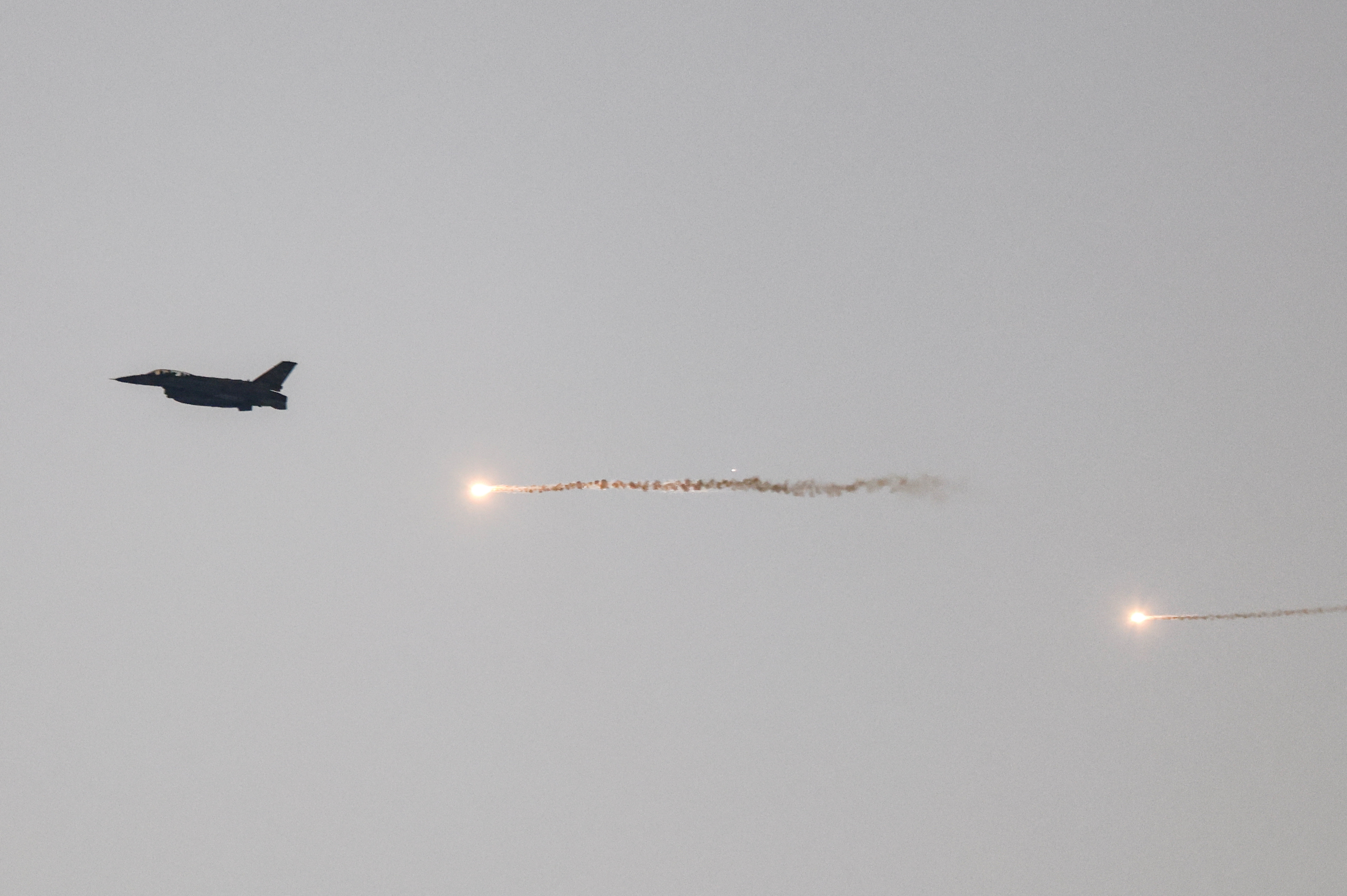 An Israeli F-16 fires flares as it flies over Gaza