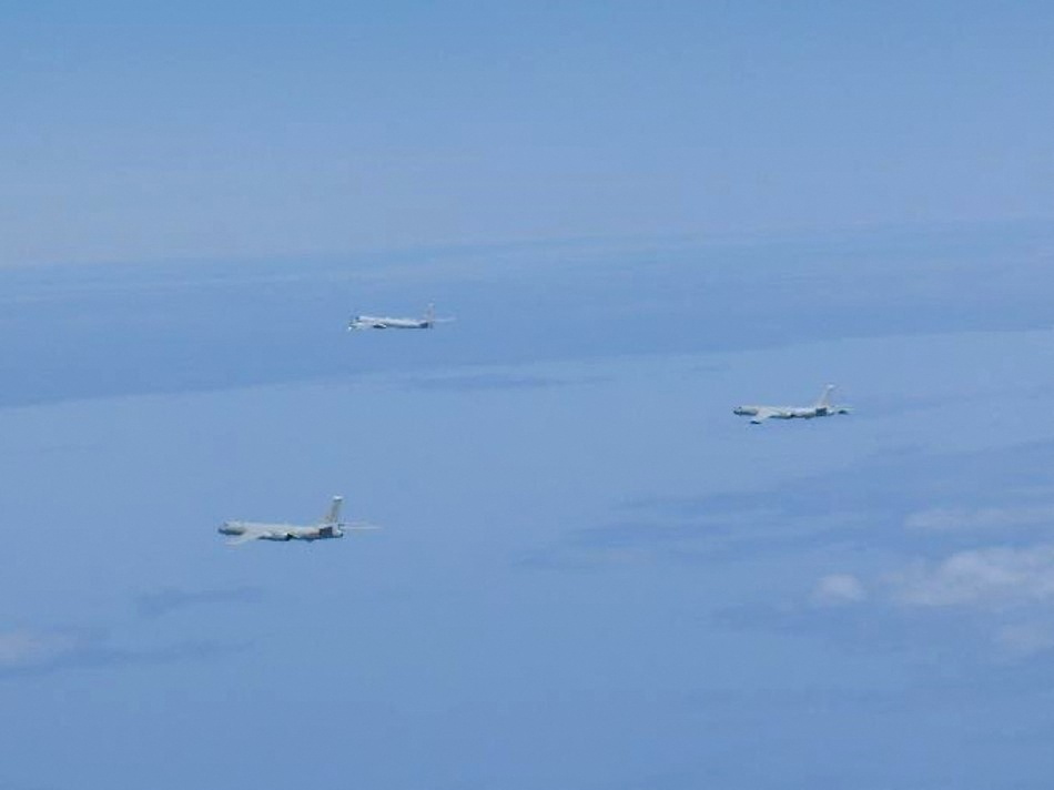 A Russian TU-95 bomber and Chinese H-6 bombers fly over East China Sea in this handout picture