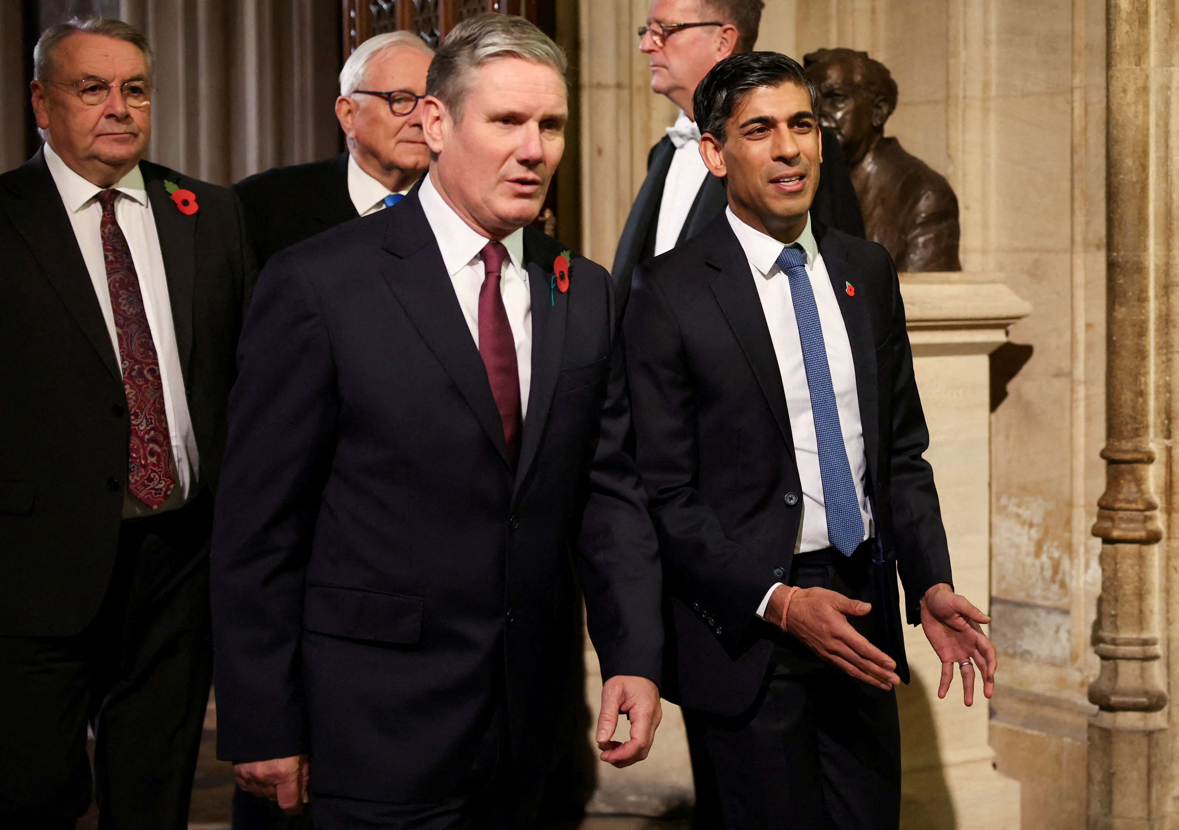 Labour Party leader Sir Keir Starmer walks with Britain's Prime Minister Rishi Sunak during the State Opening of Parliament ceremony, at the Houses of Parliament