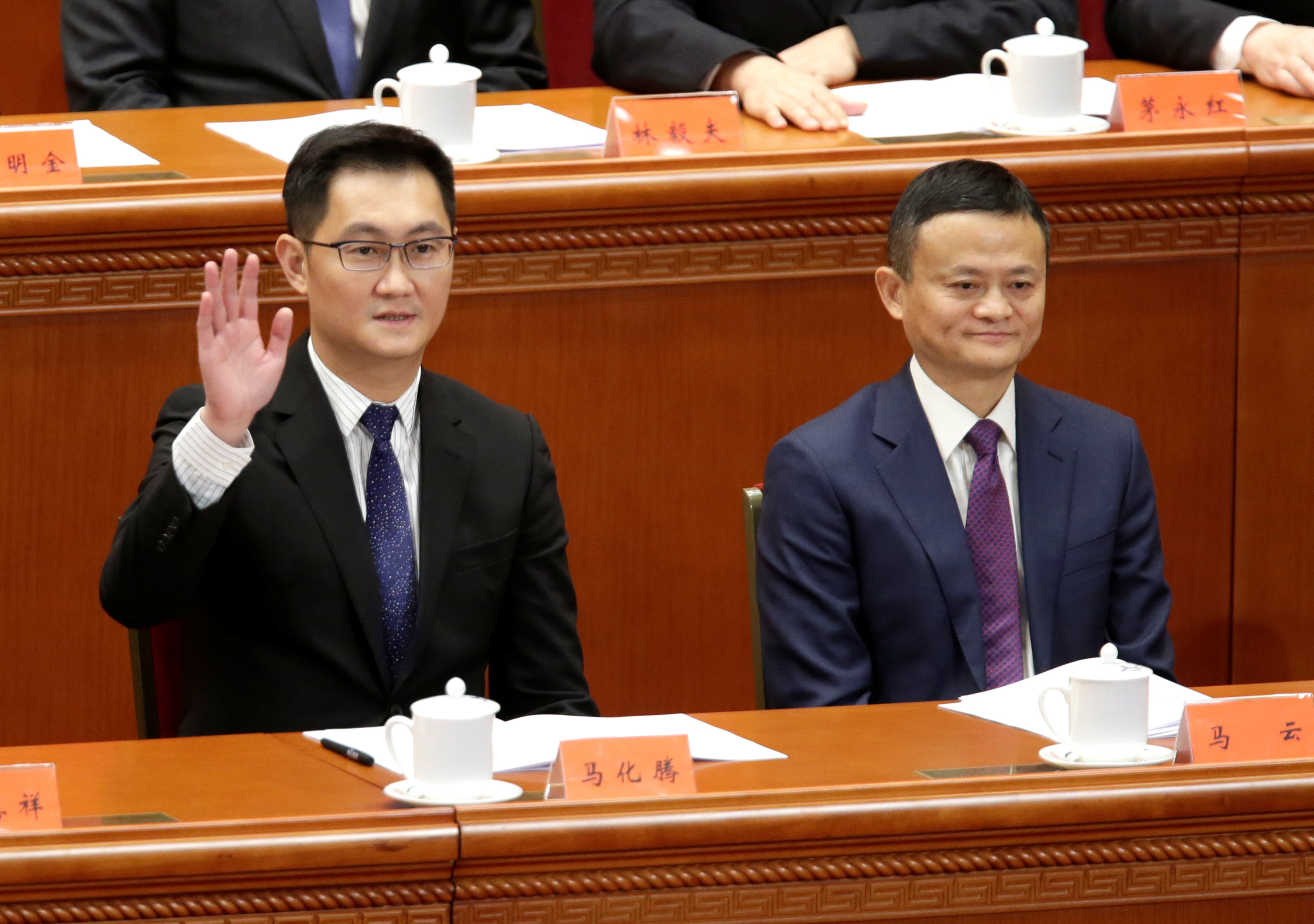 Tencent's Chief Executive Officer Pony Ma waves next to Alibaba's Executive Chairman Jack Ma at an event marking the 40th anniversary of China's reform in Beijing