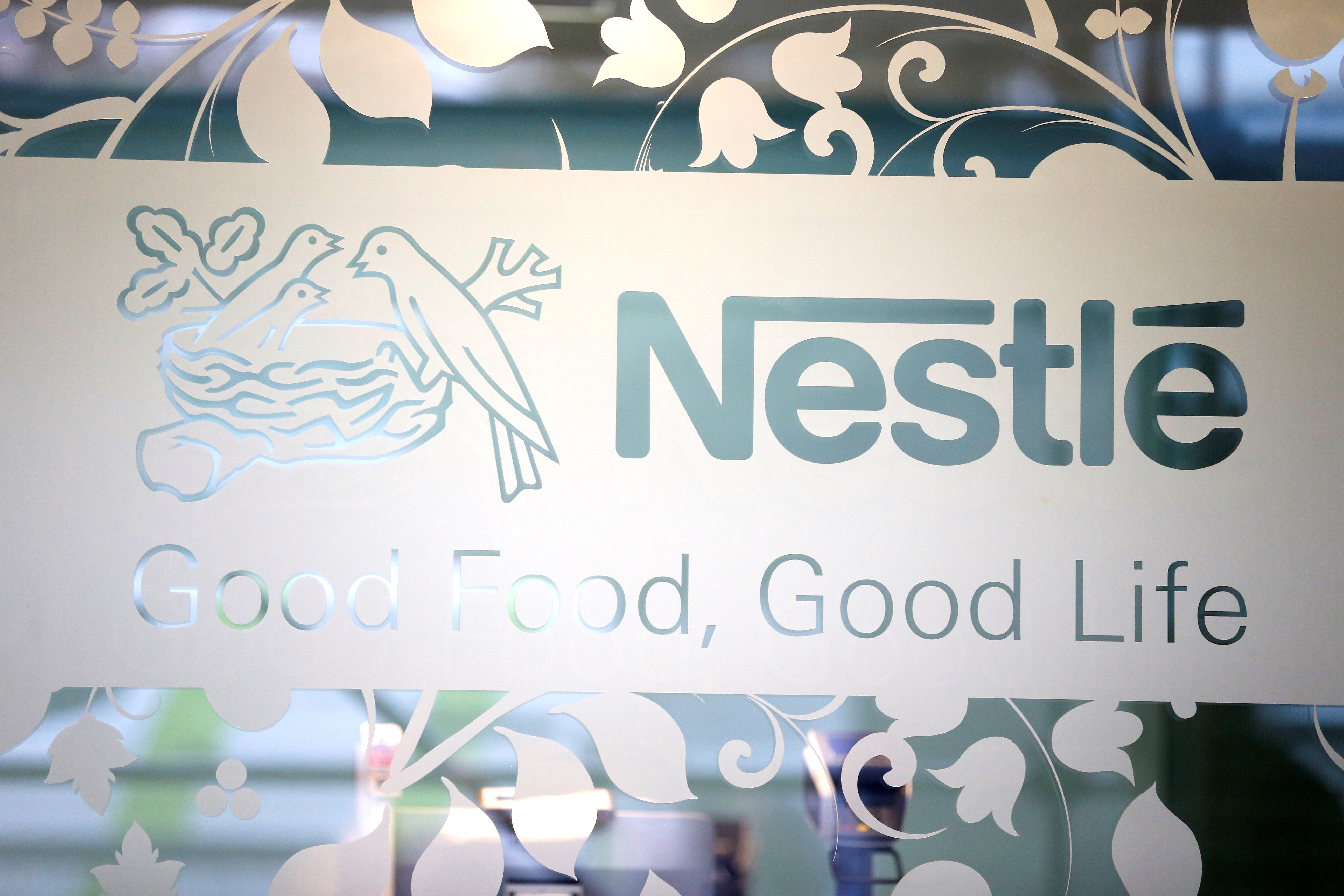 Nestle logo is pictured on the door of the supermarket of Nestle headquarters in Vevey