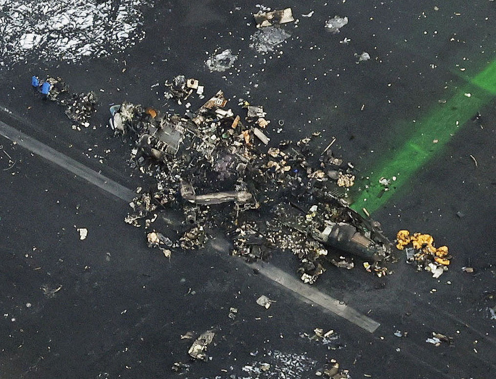 An aerial view shows burnt Japan Coast Guard aircraft after a collision with Japan Airlines' (JAL) Airbus A350 plane in Tokyo