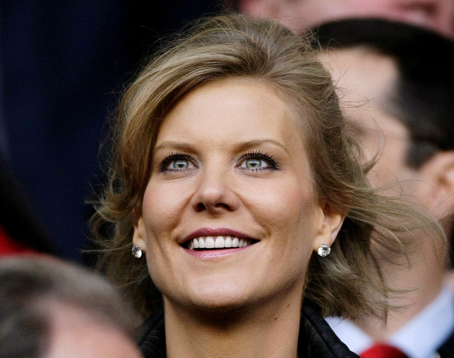 Dubai International Capital's chief negotiator Staveley smiles before the Champions League semi-final match in Liverpool